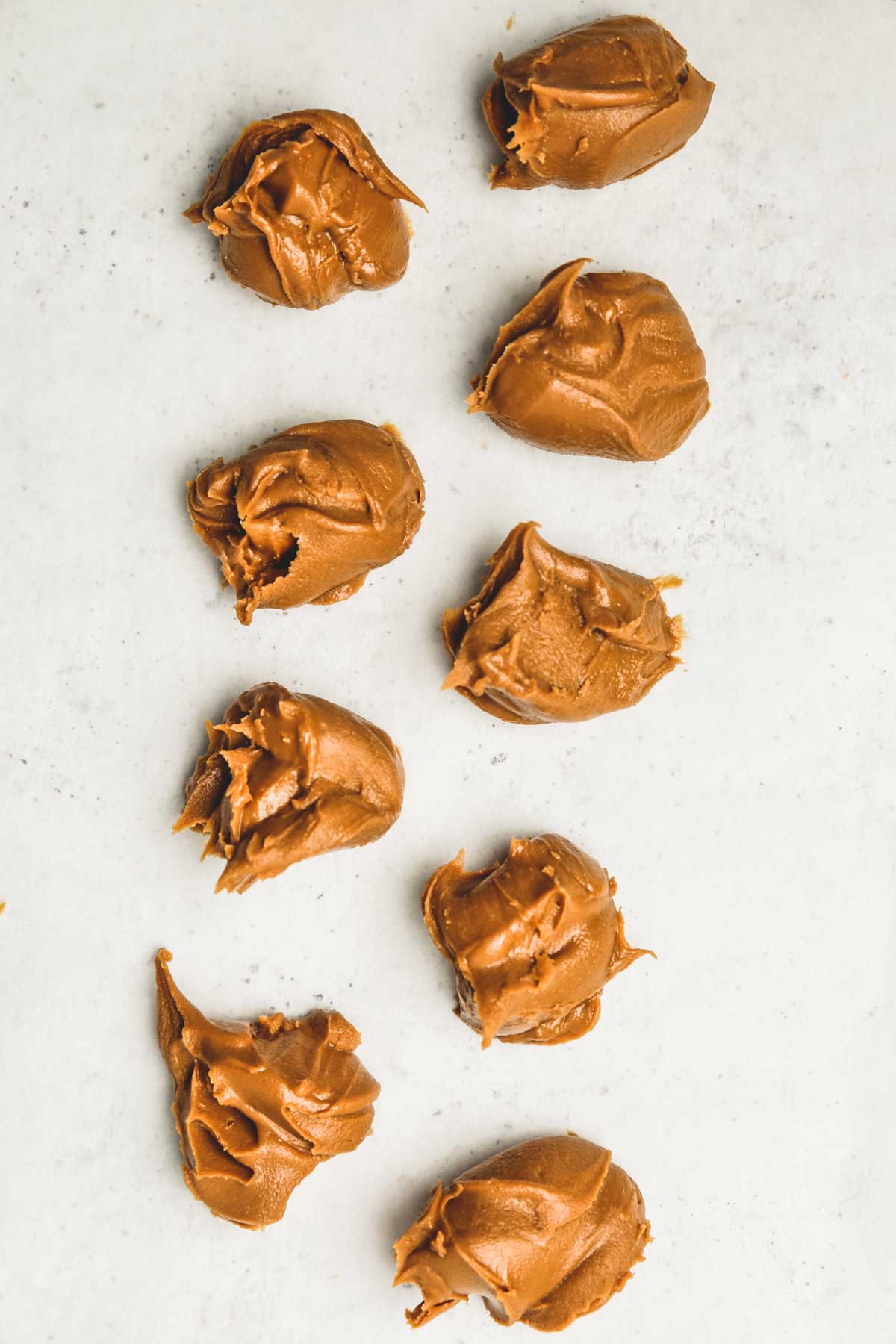 frozen scoops of Biscoff spread on parchment paper