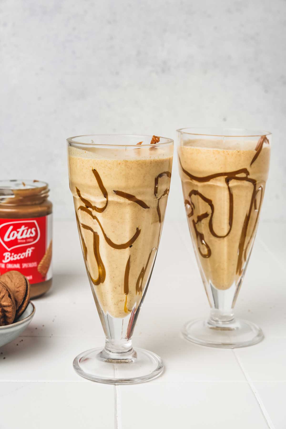 2 glasses of biscoff milkshake on a table