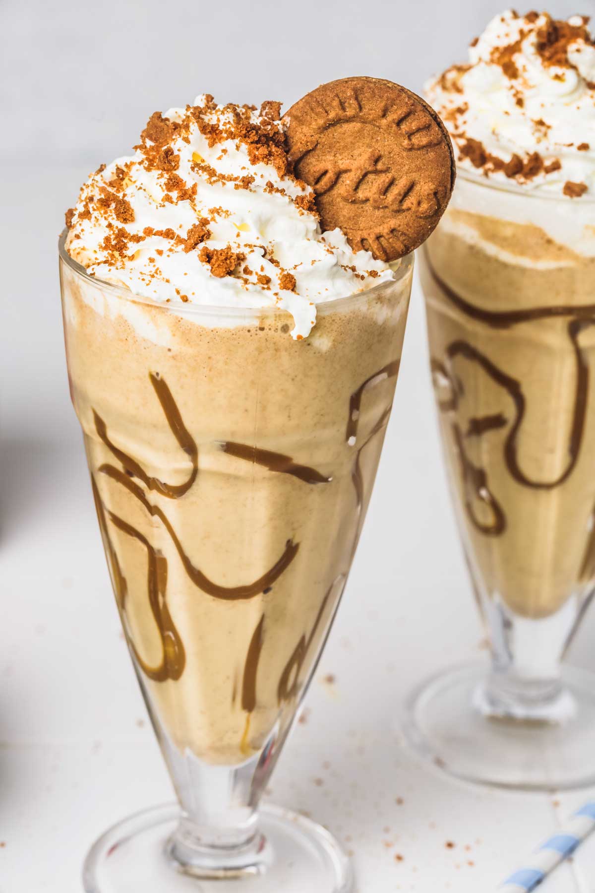 2 glasses of biscoff milkshake on a table