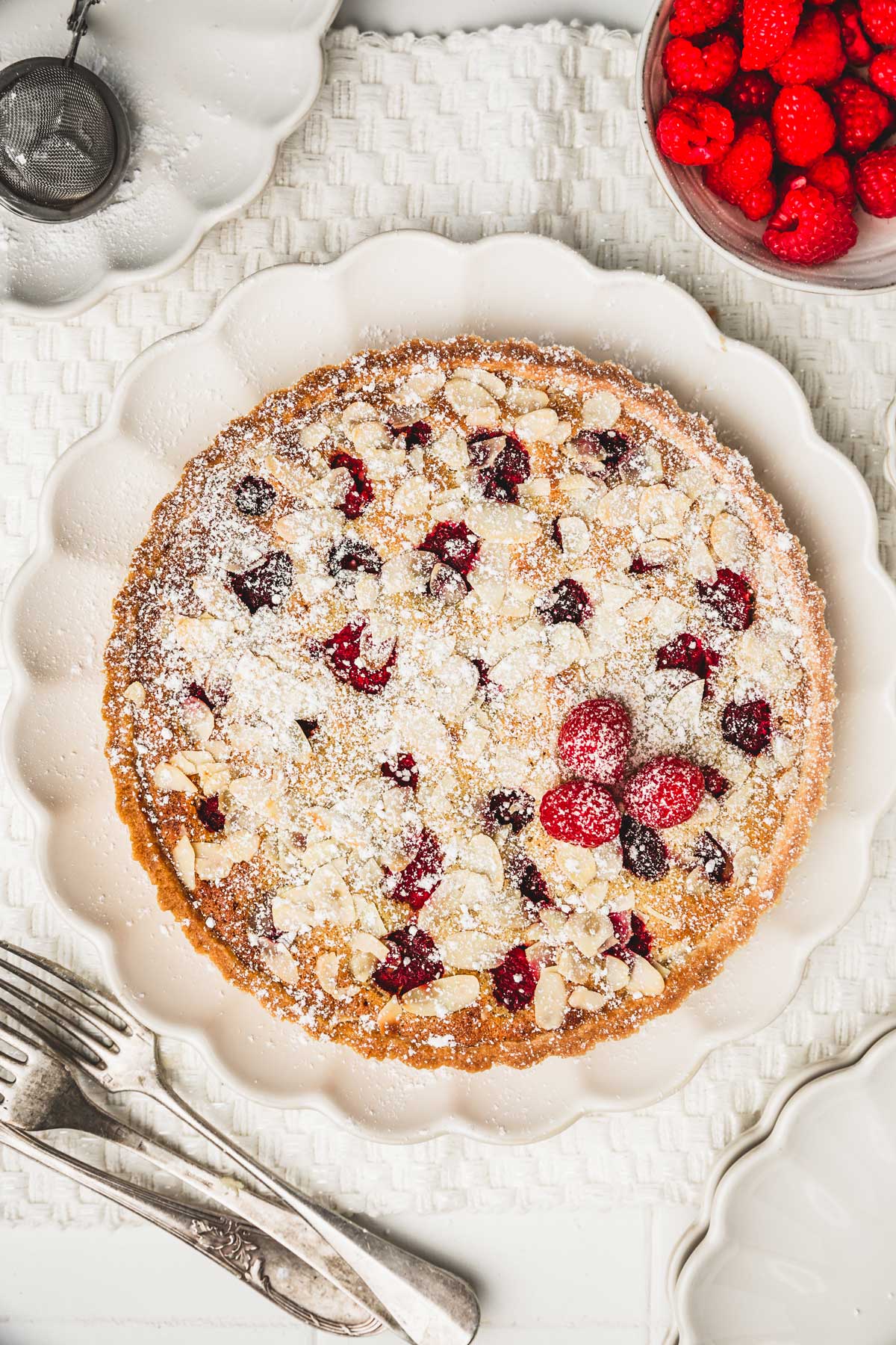 frangipane tart with raspberry on a plate