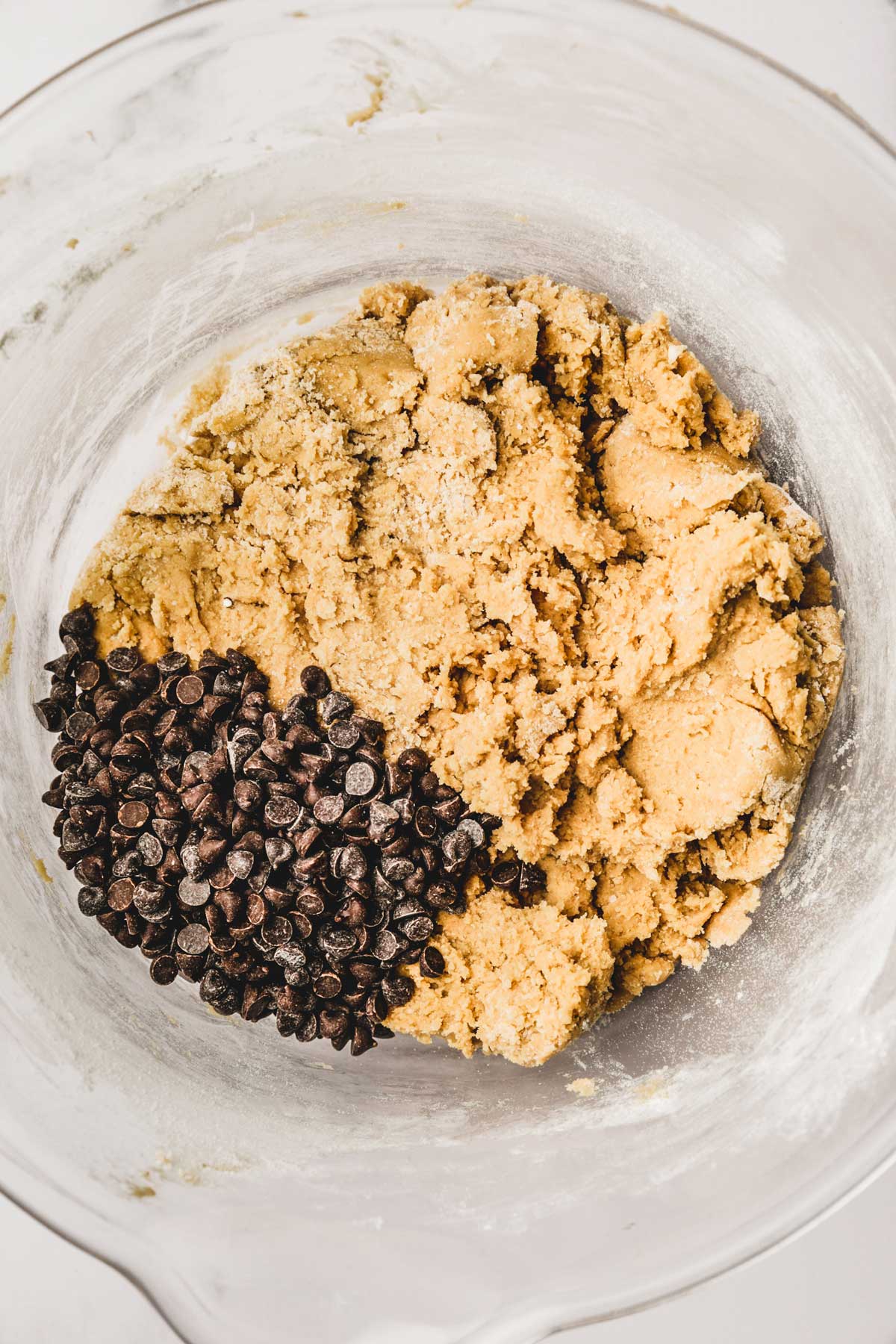 chocolate chip cookie dough with chocolate chips in mixing bowl