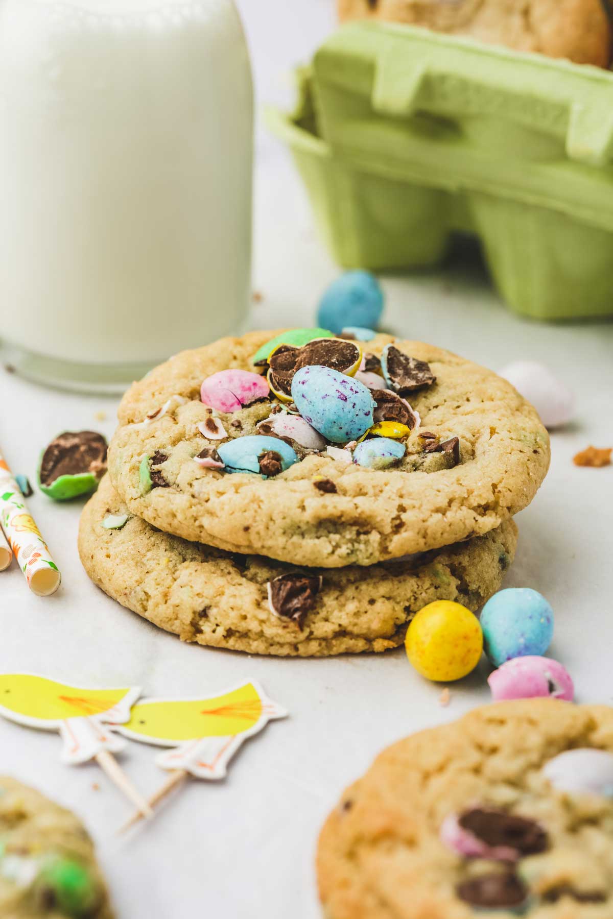 2 mini egg easter cookies on a table with a milk bottle