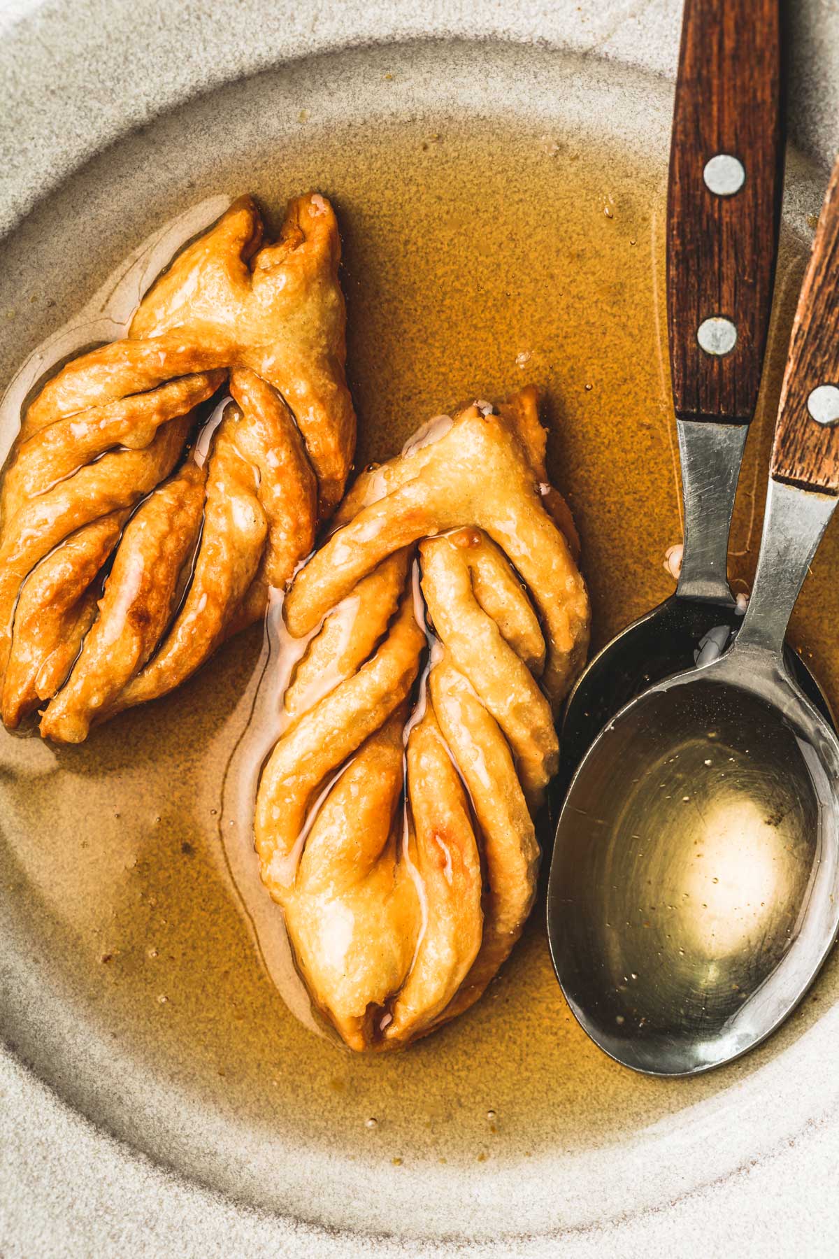 chebakia cookies on a plate with honey syrup