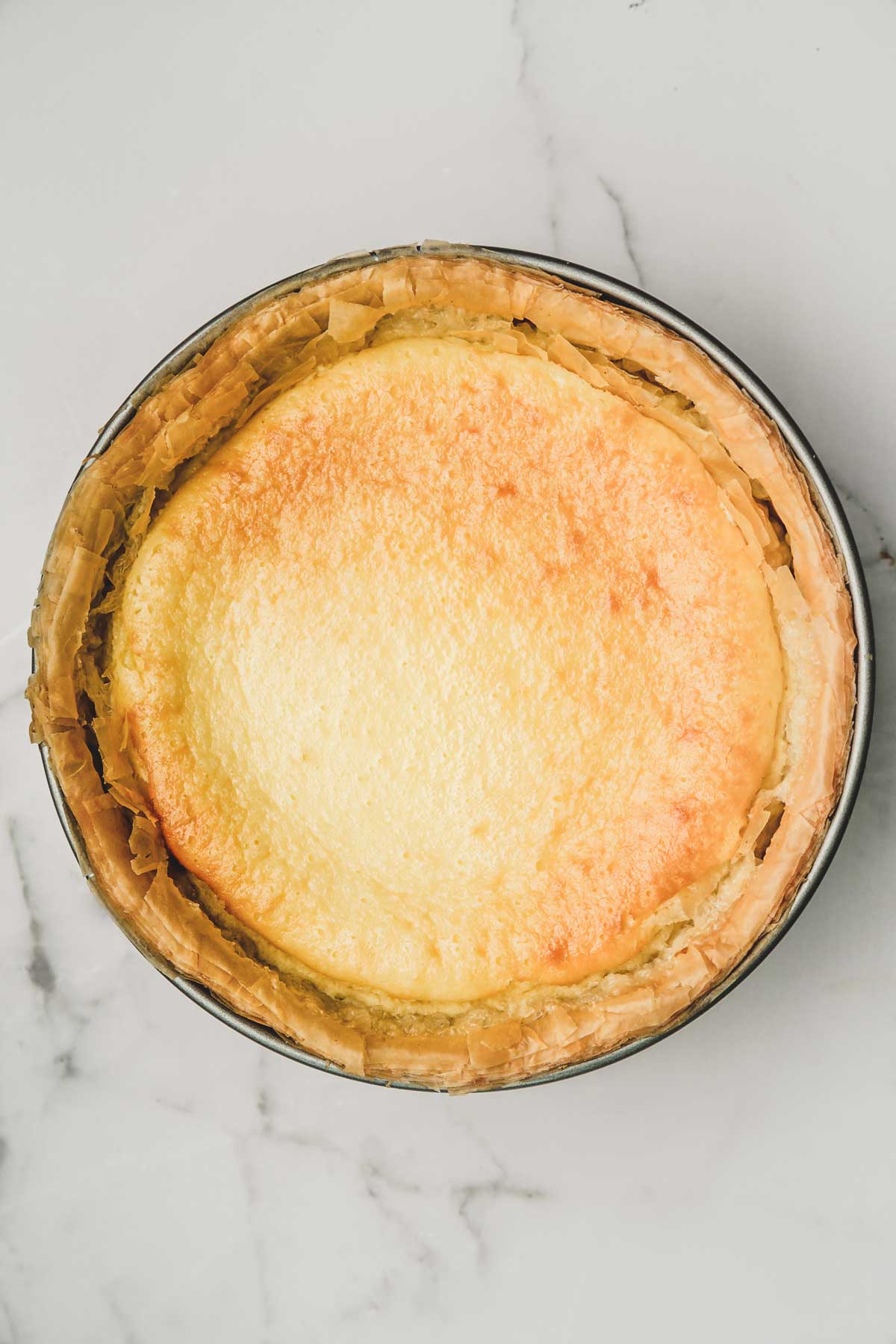 springform pan with baked cheesecake