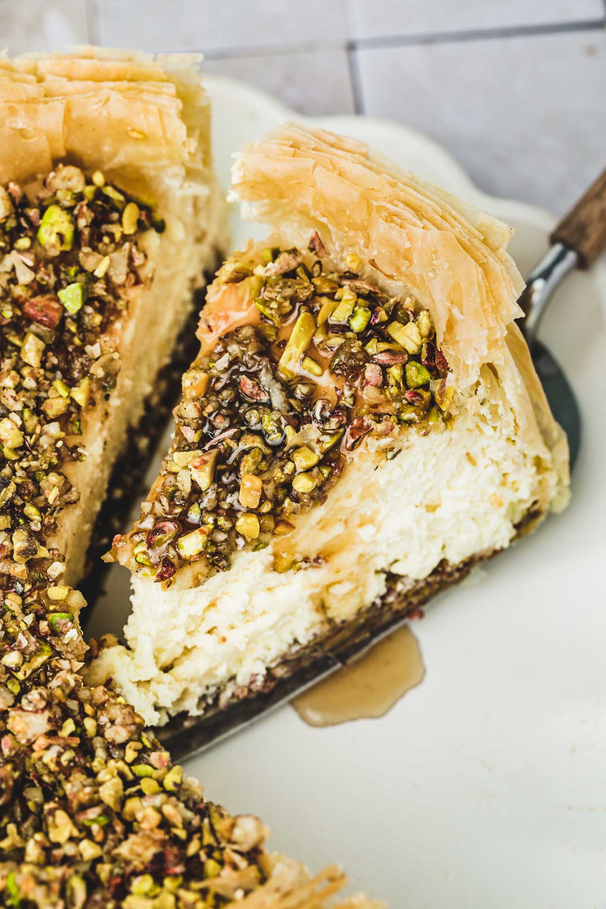 baklava cheesecake sliced on a plate