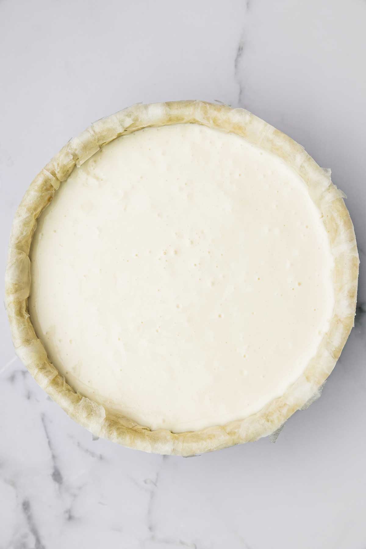 cake pan with cheesecake batter