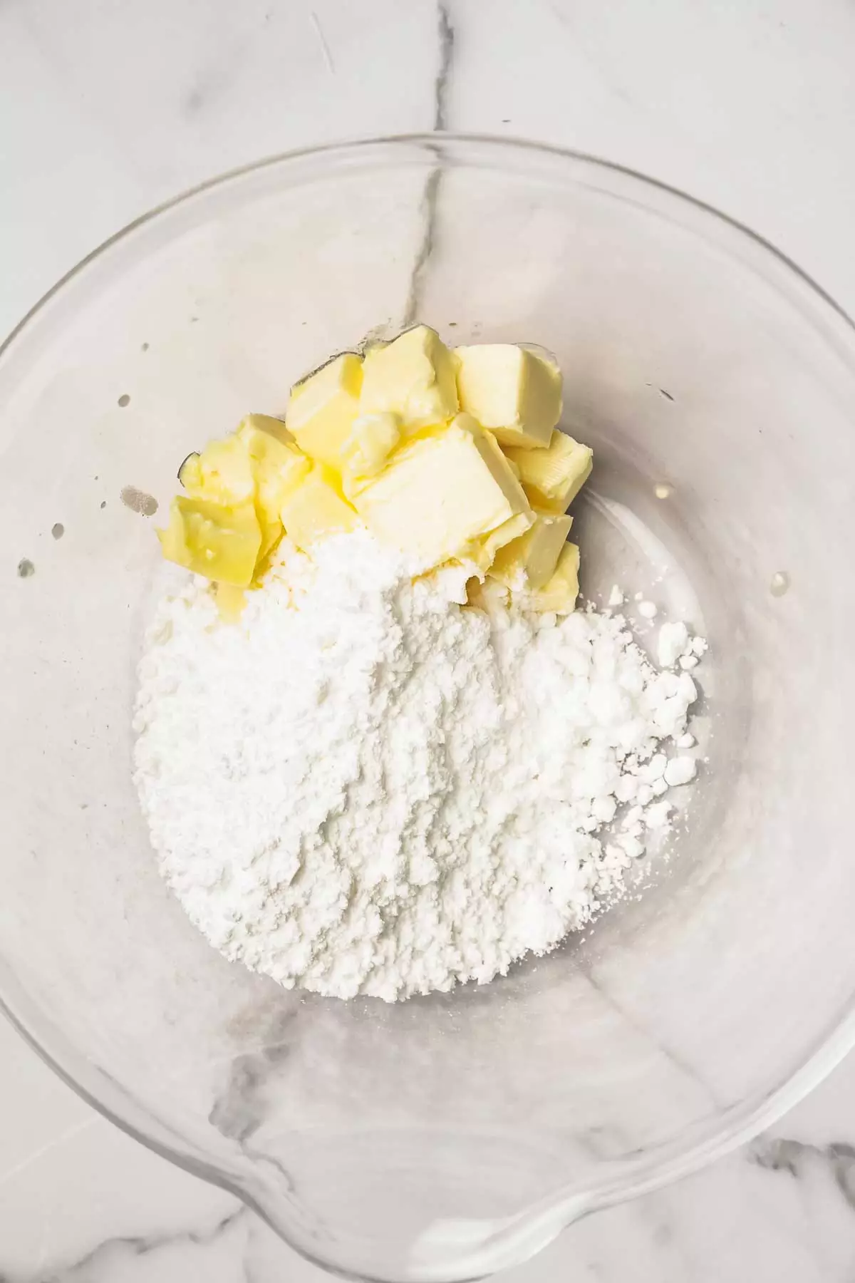 mixing bowl with powdered sugar and butter