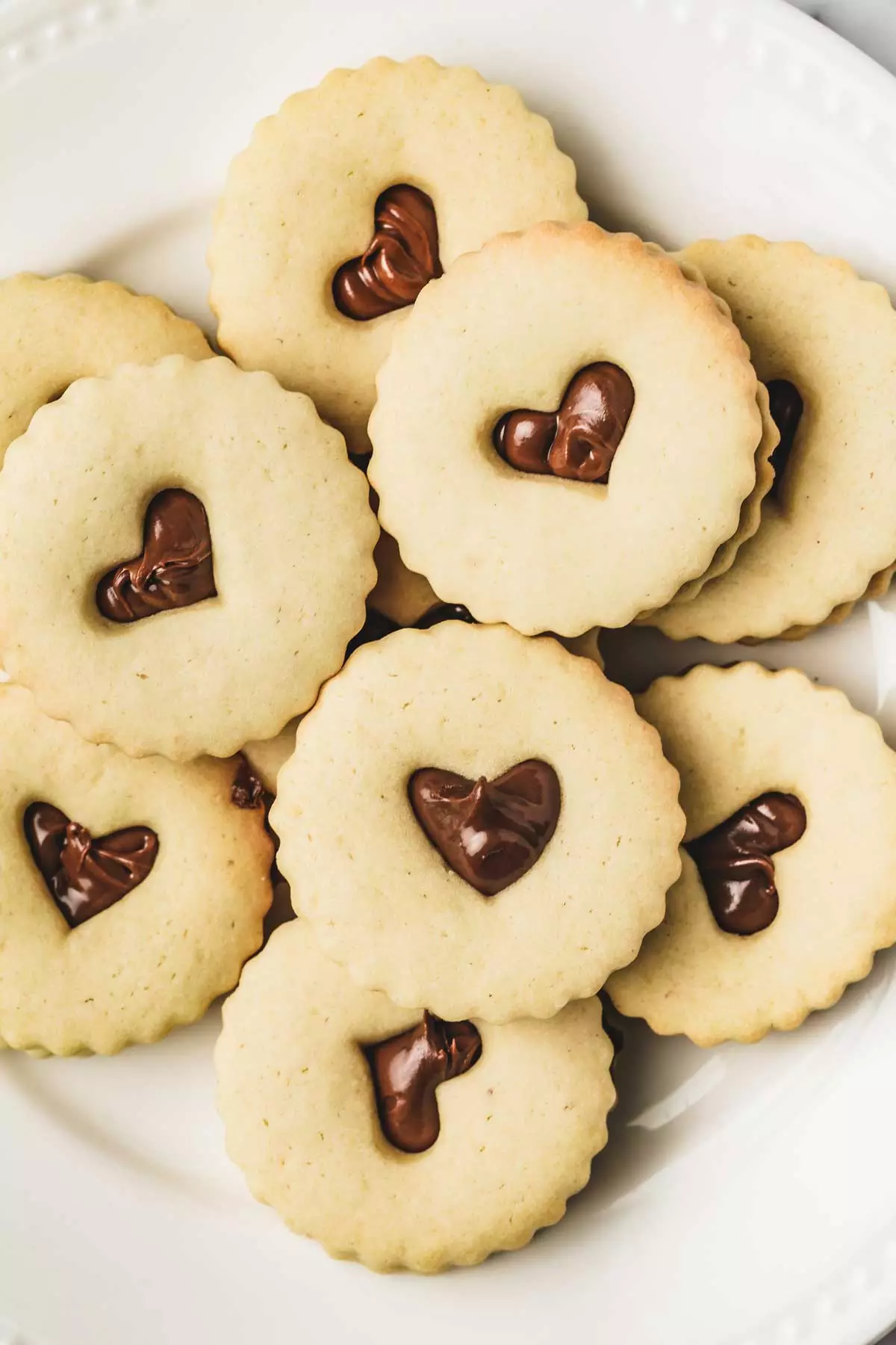 nutella filled linzer cookies on a plate