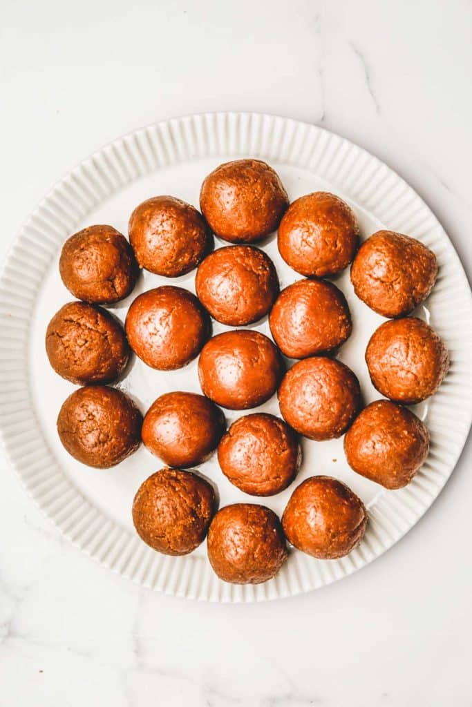 Rolled Biscoff cookie butter truffles on a plate before coating
