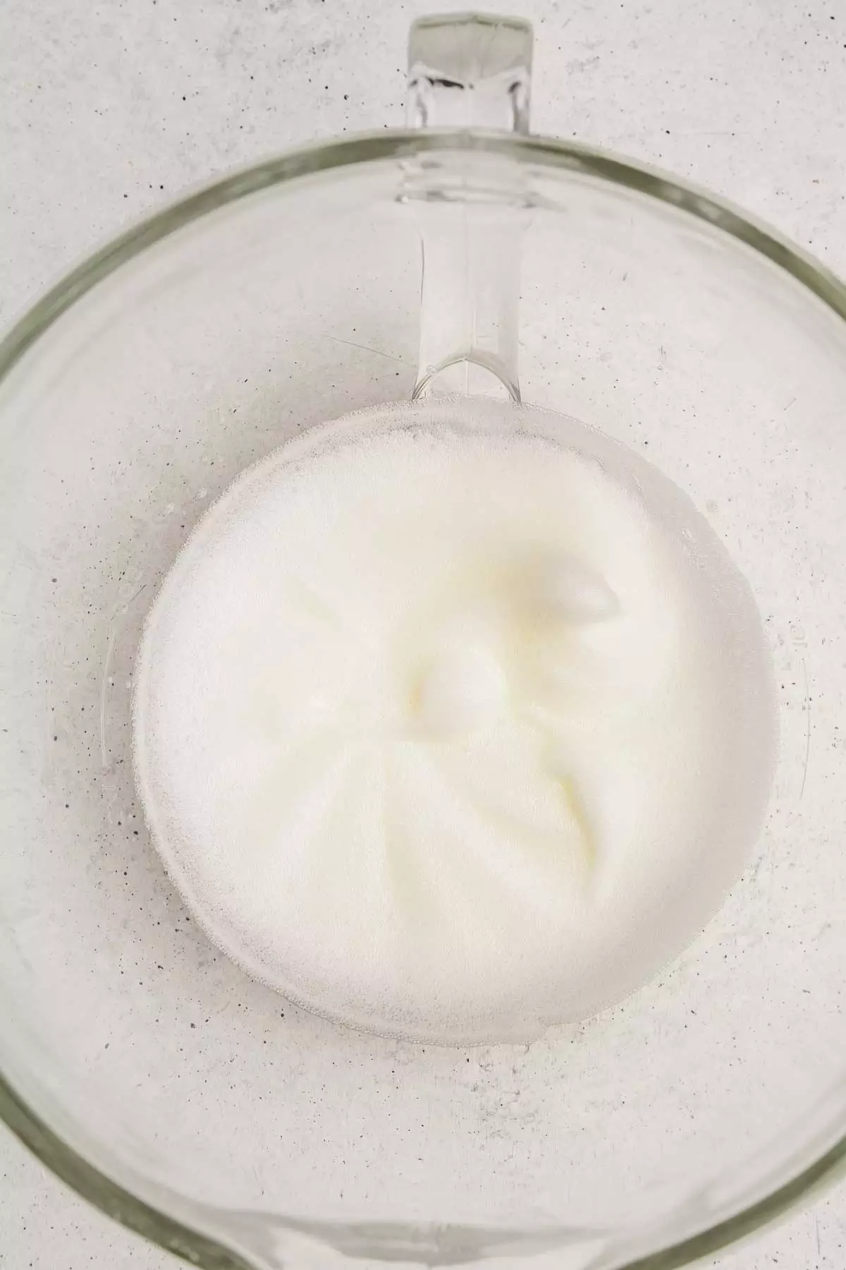 large bowl with foamy eggs whites