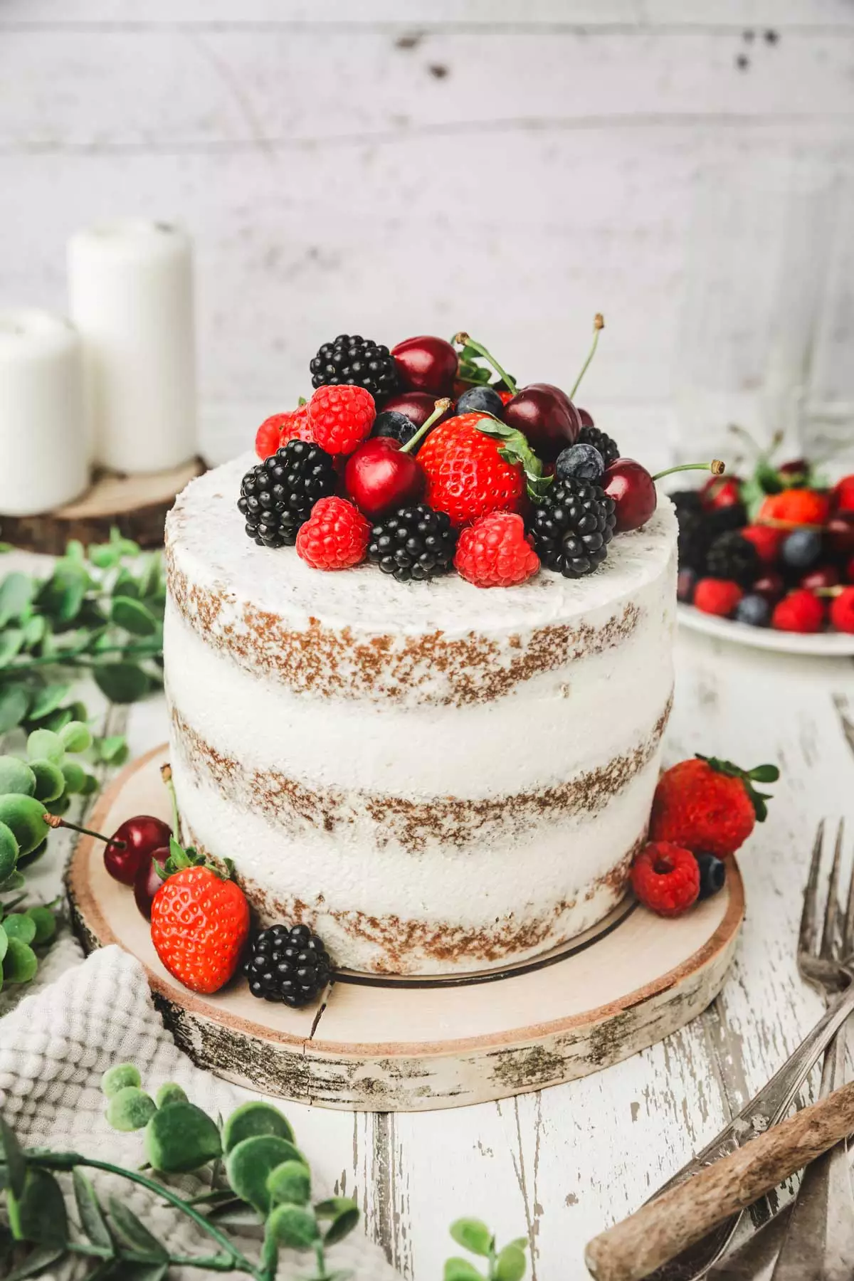 naked cake with fresh berries on a table