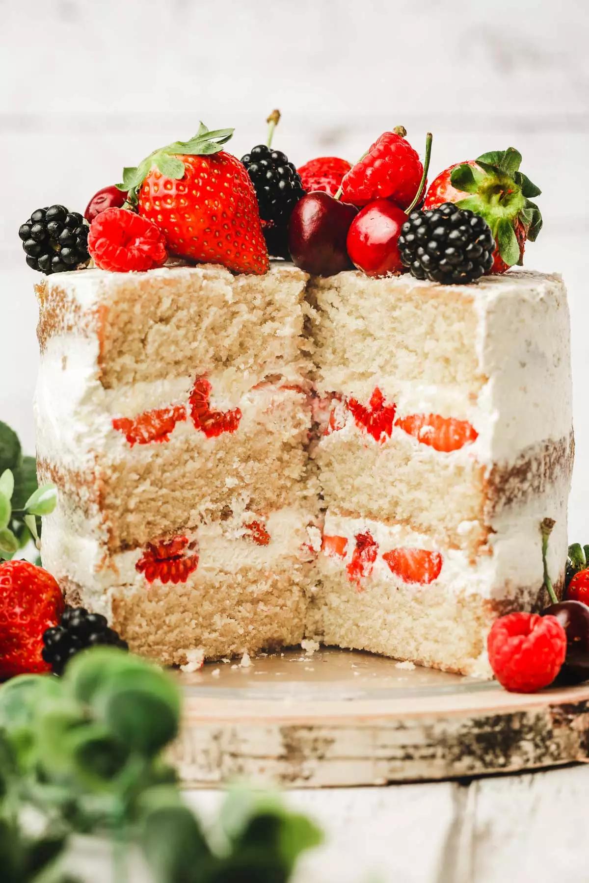 berry naked cake cutted on a table