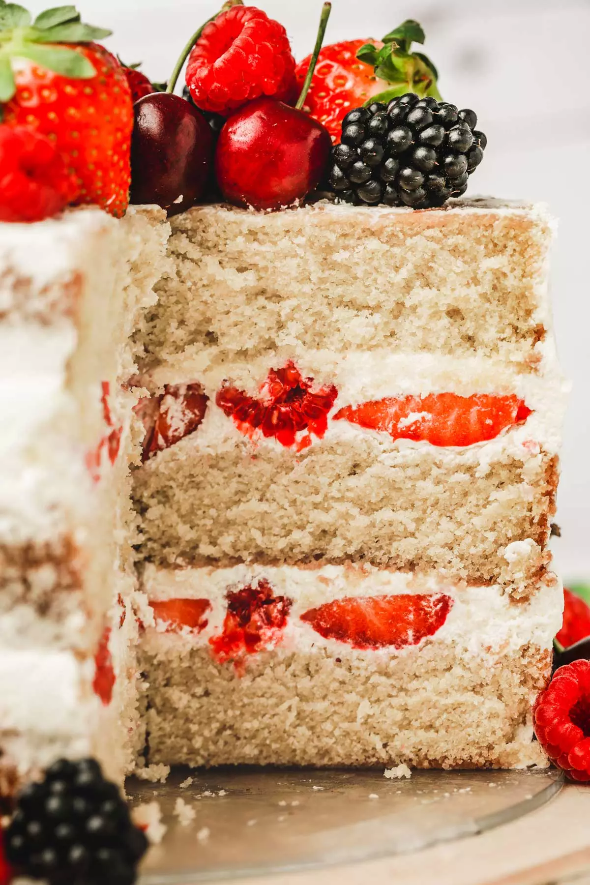 semi naked cake with fresh berries cutted on a table