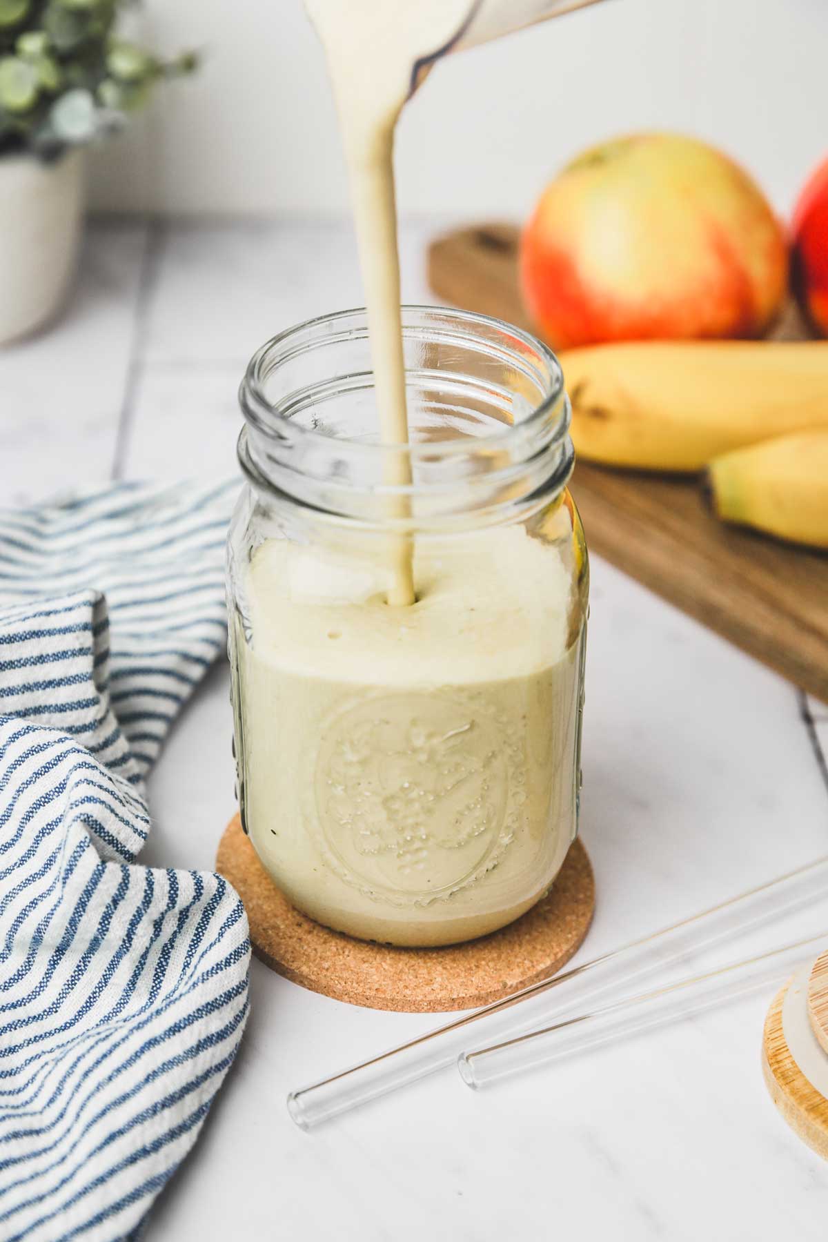 glass jar with apple banana smoothie