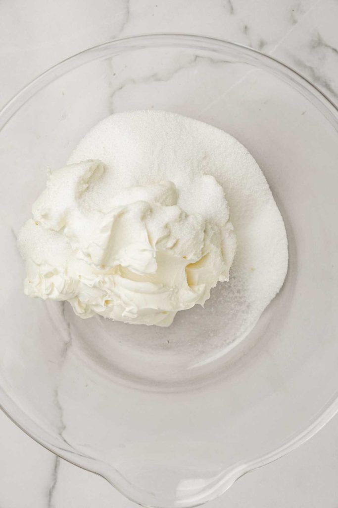 cream cheese and sugar in a large bowl