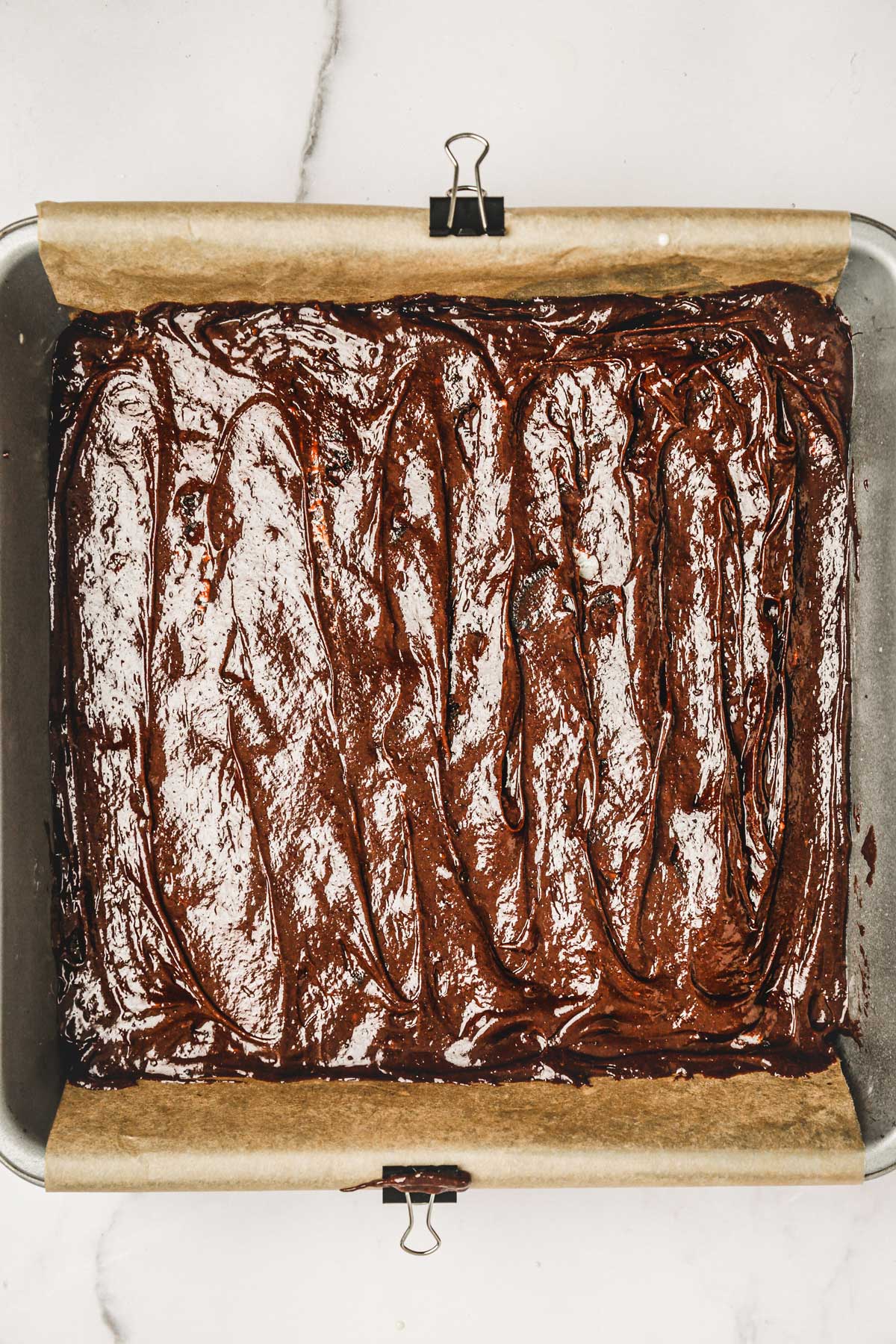 square pan with chocolate brownies batter