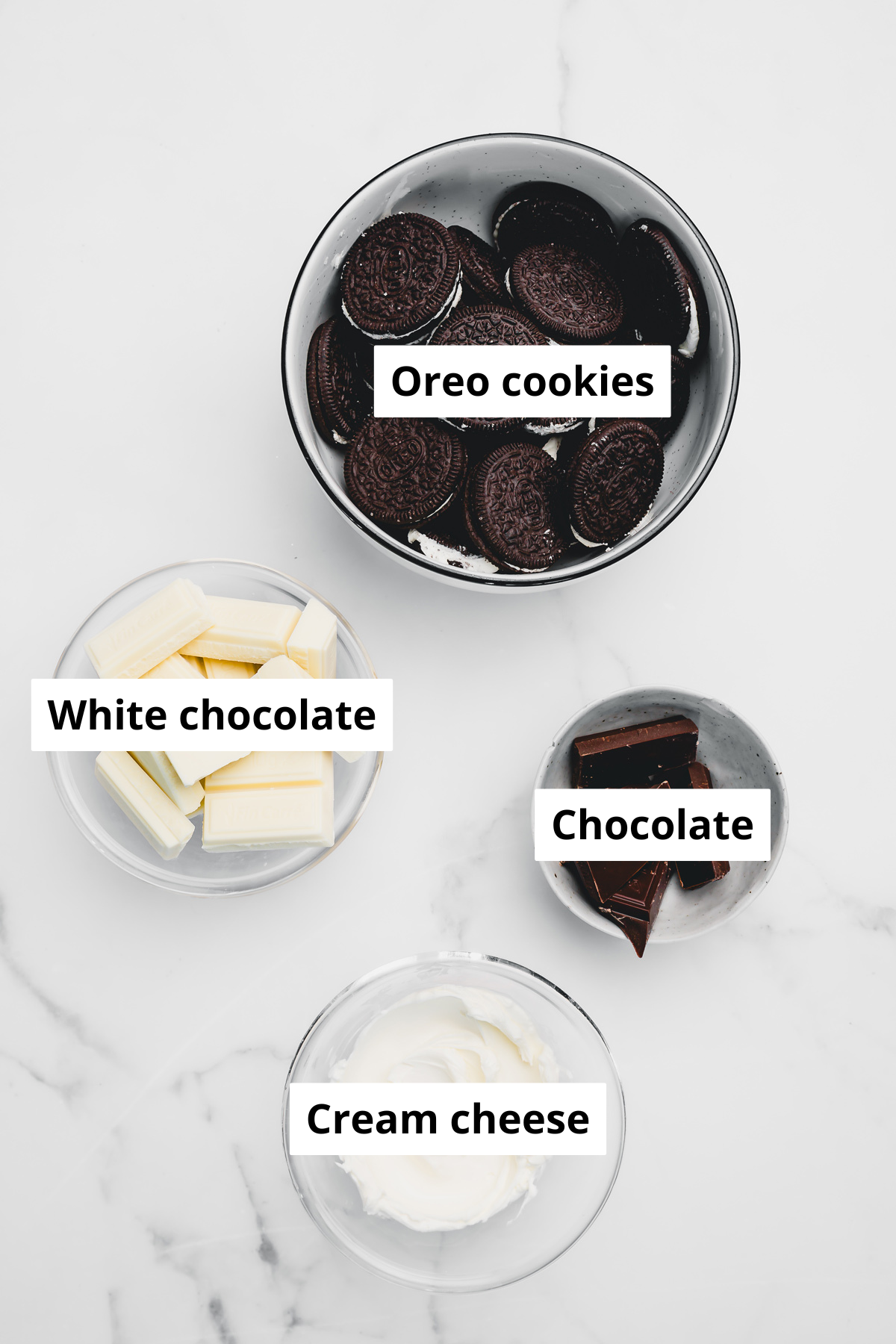 Bowls with Oreo cake pops ingredients – crushed Oreos, cream cheese, and melted white chocolate for an easy no-bake Oreo cake pops recipe.
