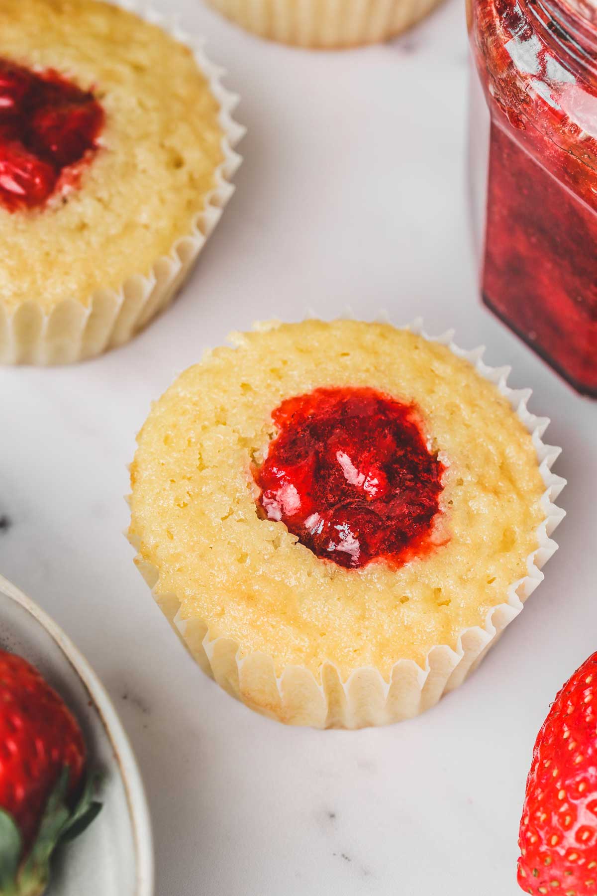 one cupcake filled with a strawberry filling