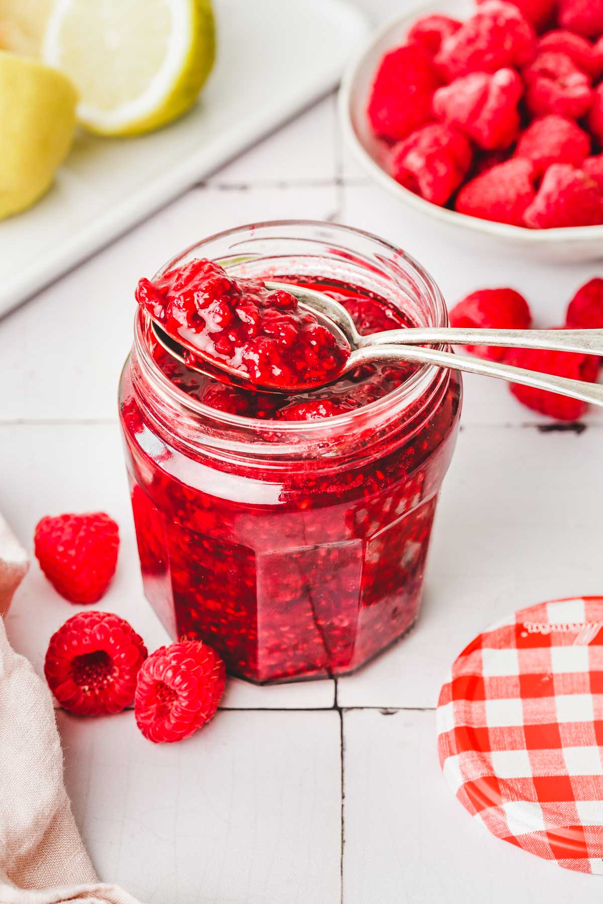 mason jar with raspberry compote in a table