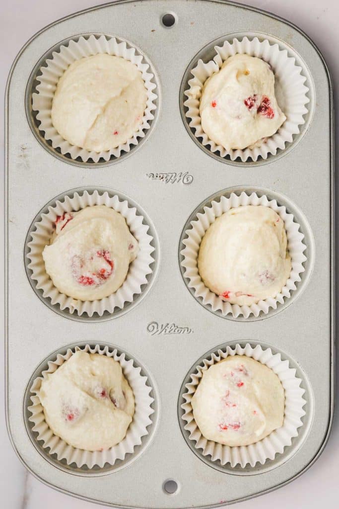 cupcake pan filled with raspberry