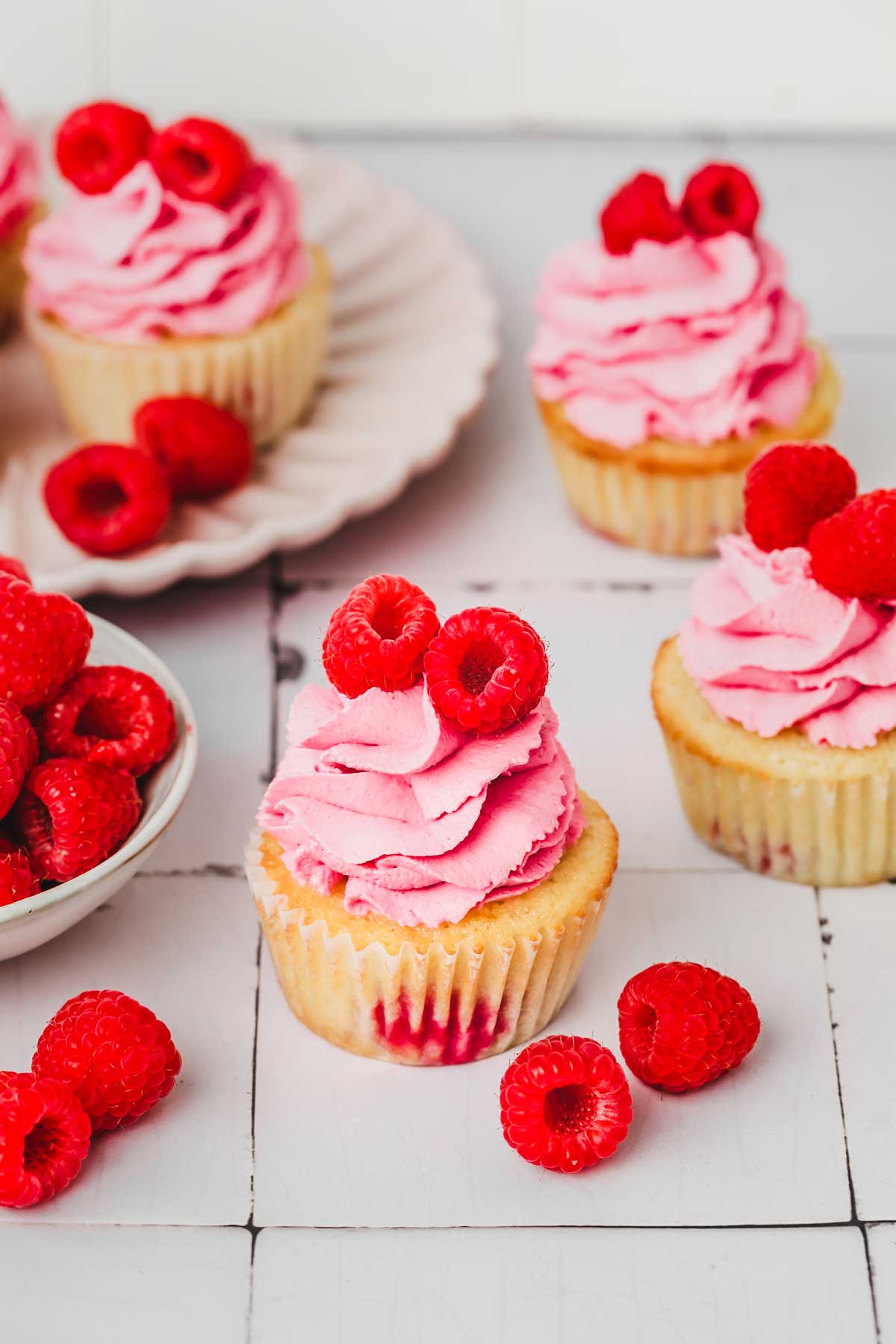 raspberry cupcakes on a table