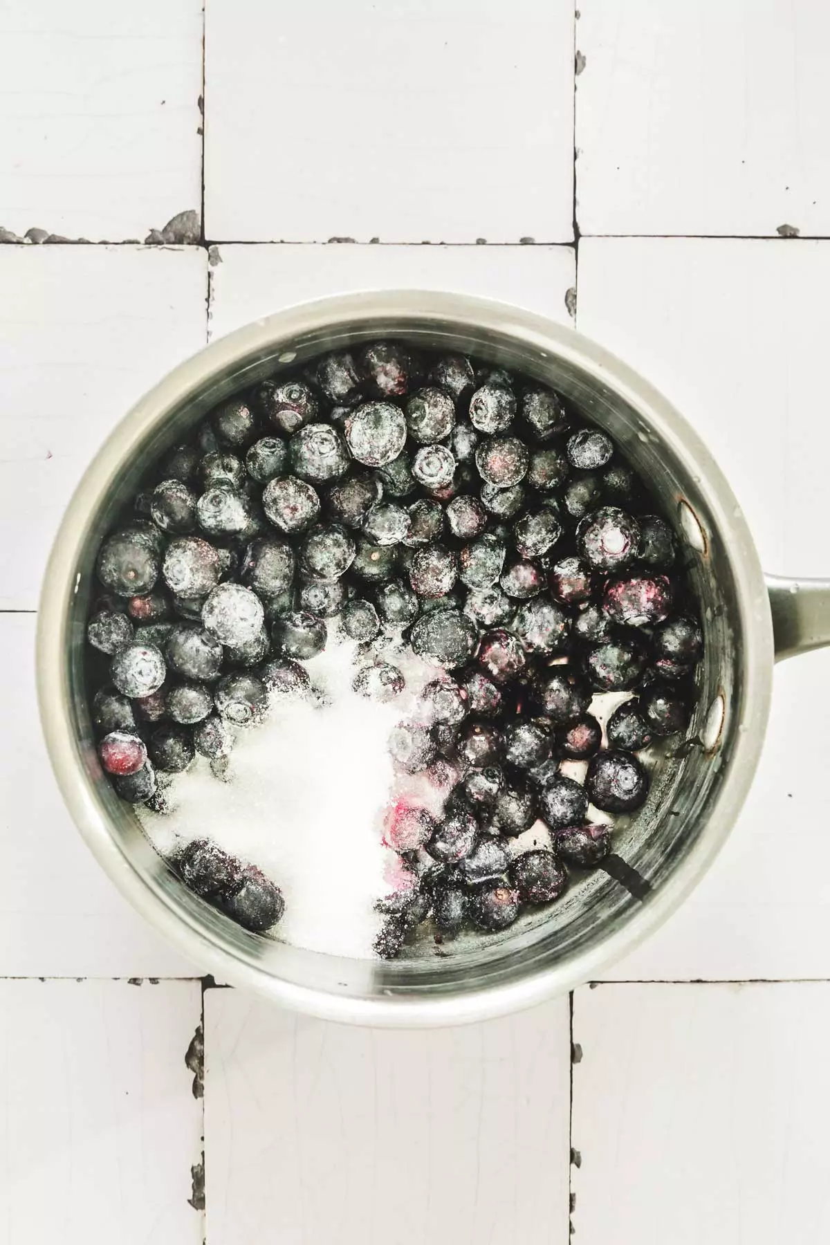 saucepan with blueberry and sugar