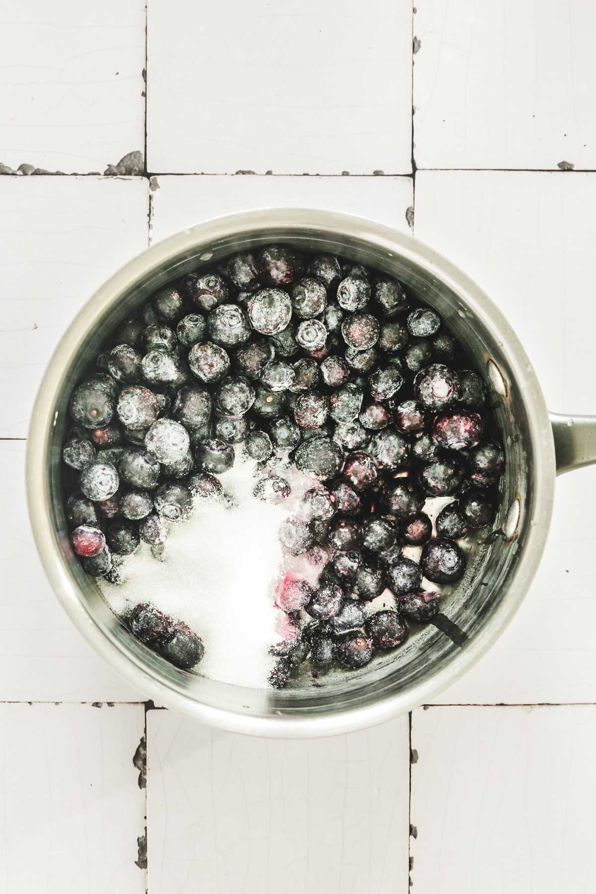 saucepan with blueberry and sugar