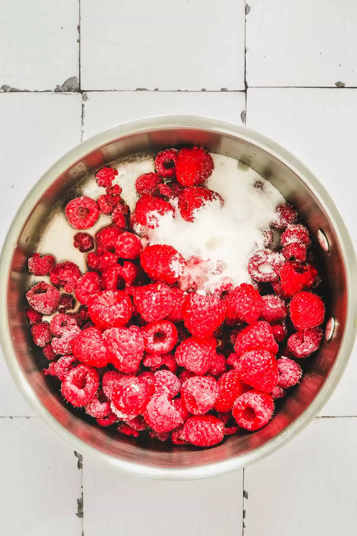 saucepan with raspberry and sugar