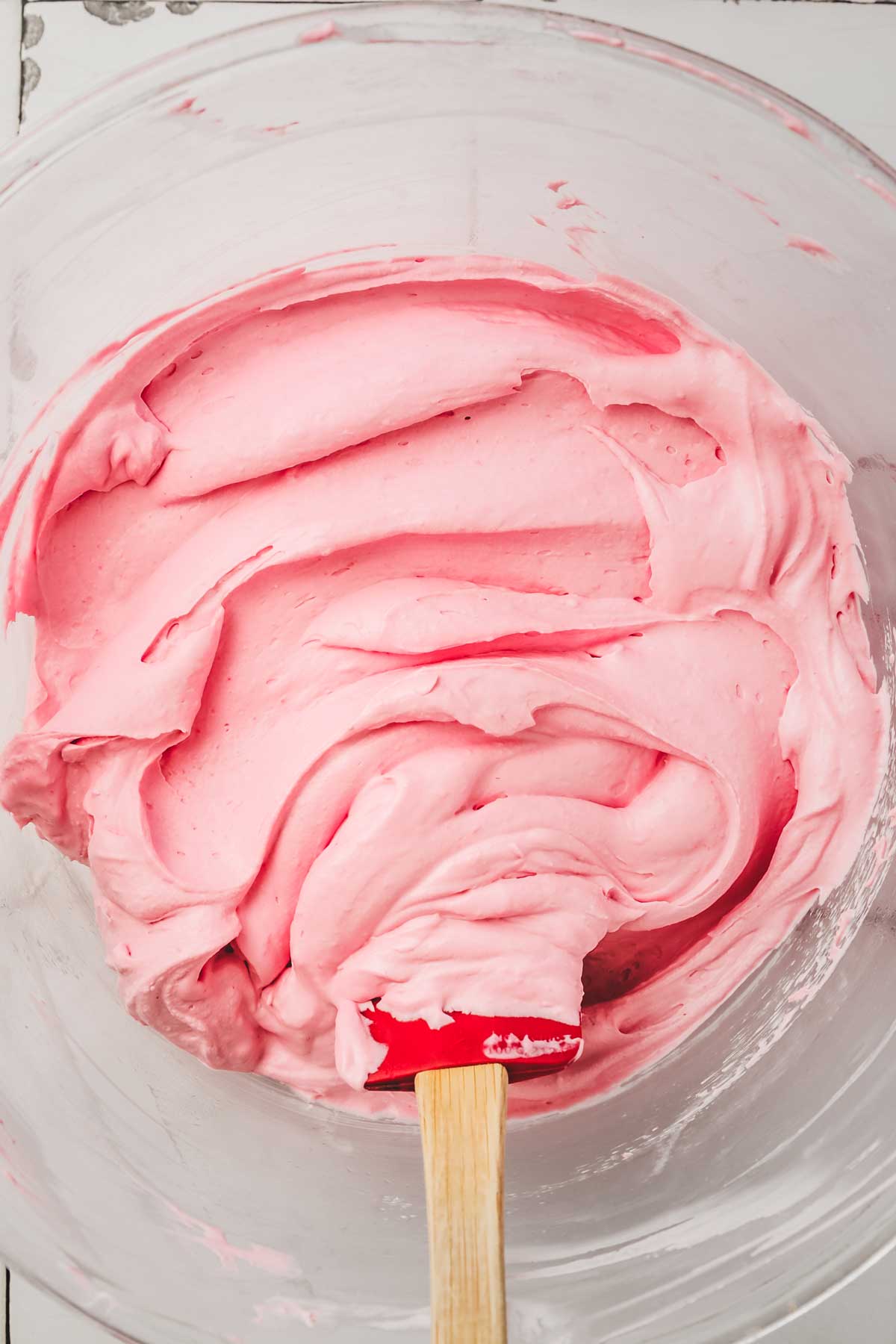 large bowl with raspberry whipped cream frosting