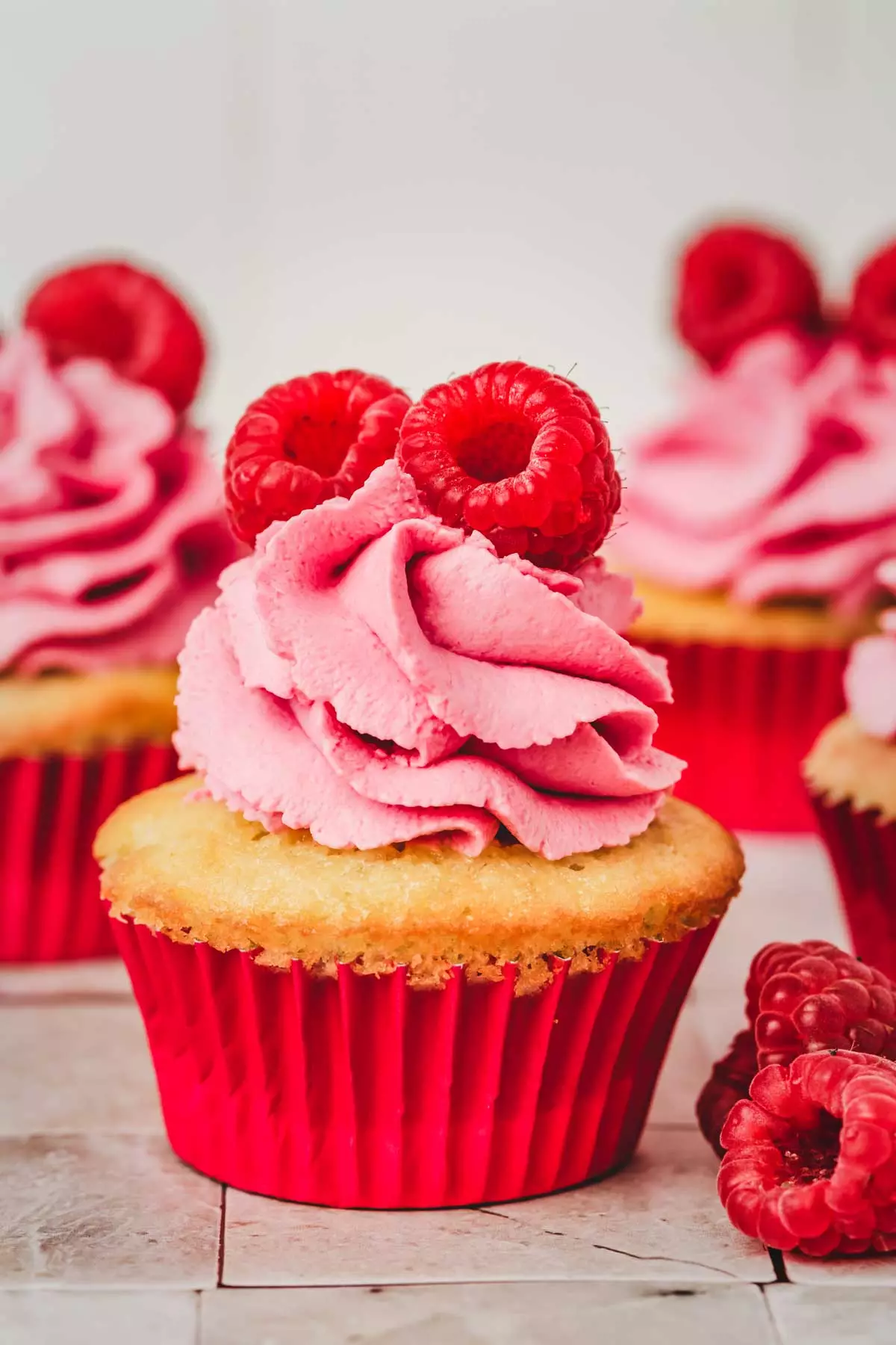 cupcake topped with raspberry frosting