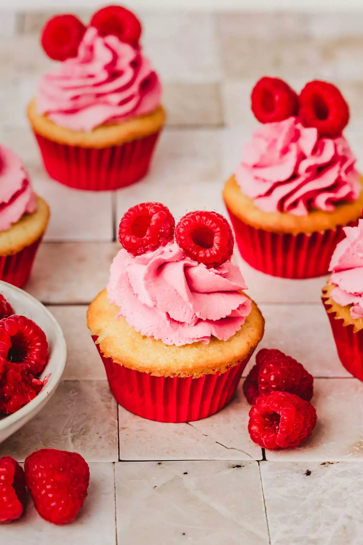 cupcakes with raspberry mascarpone frosting on a table