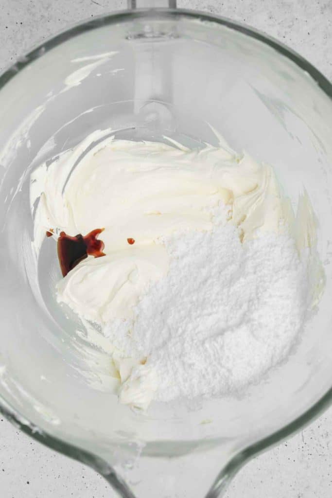 large bowl with whipped butter, vanilla and powdered sugar