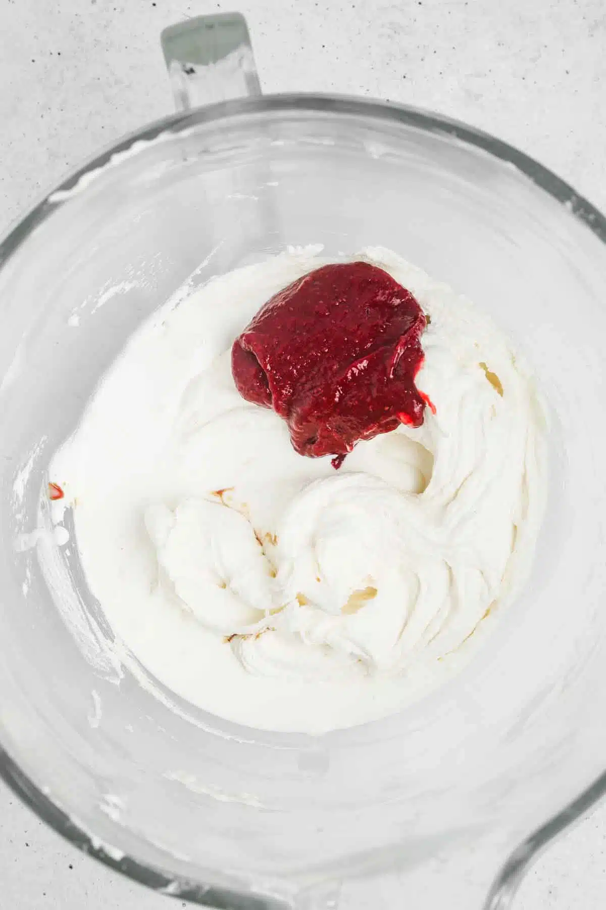 large mixing bowl with buttercream and strawberry puree