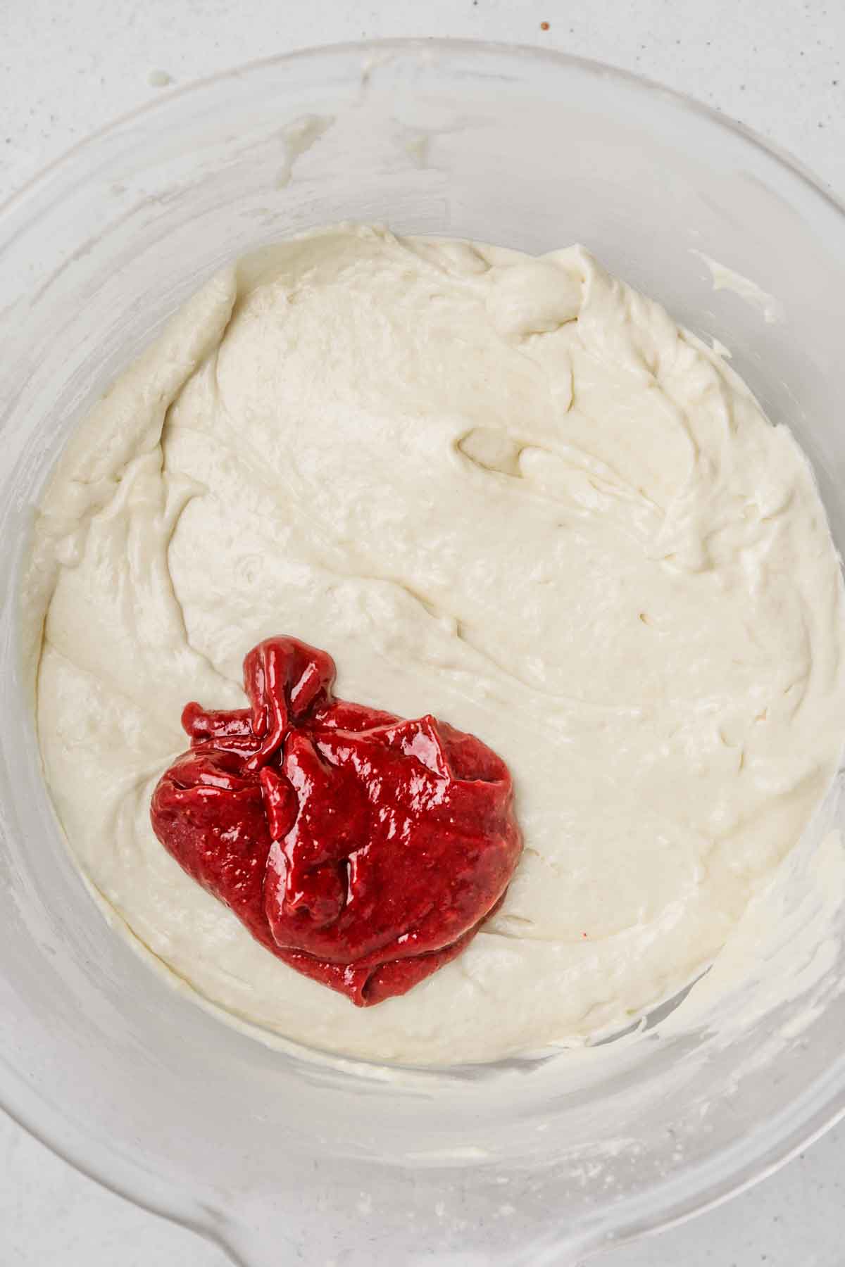 large mixing bowl with cake batter and strawberry reduction