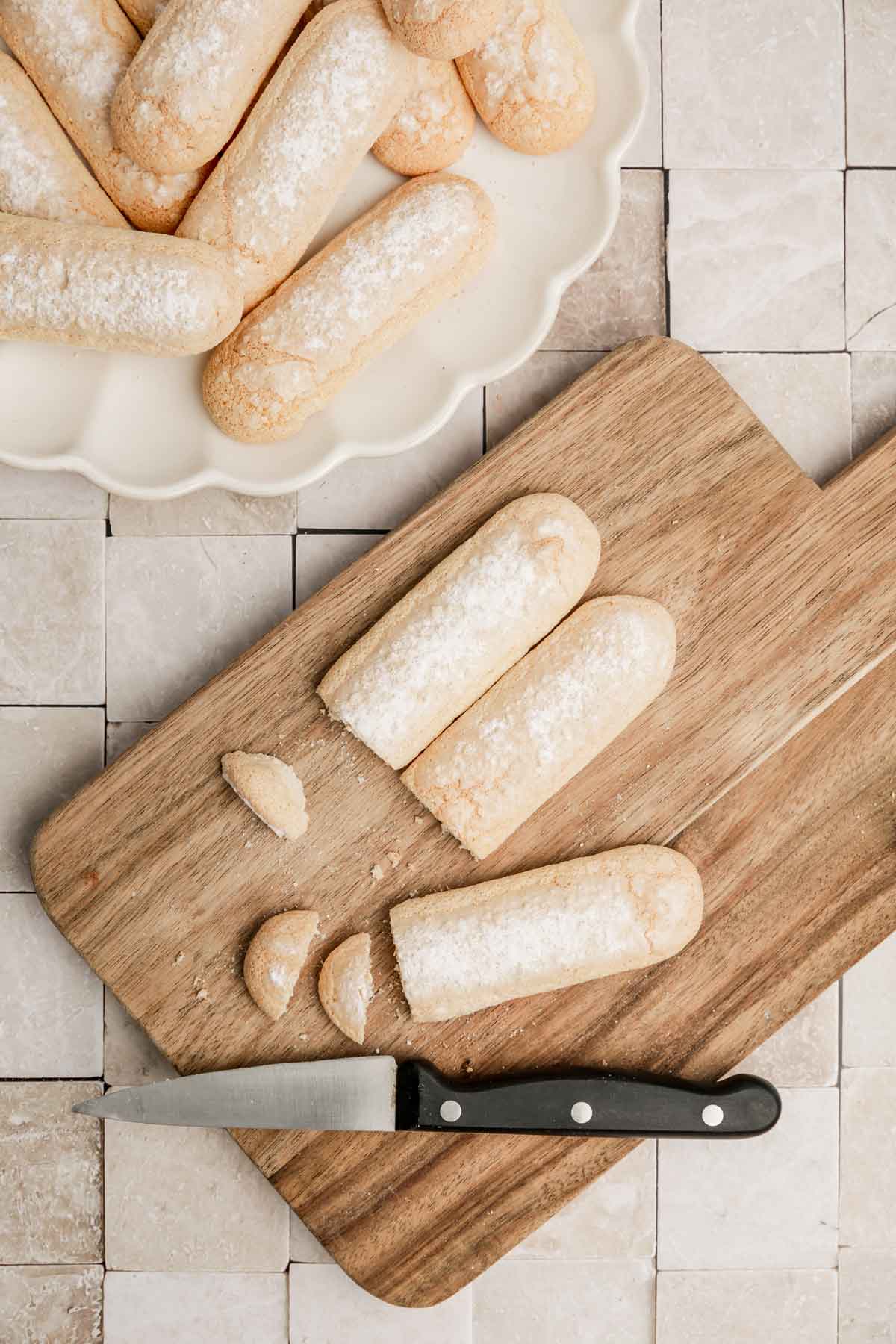 cutting board with ladyfingers biscuits cutted