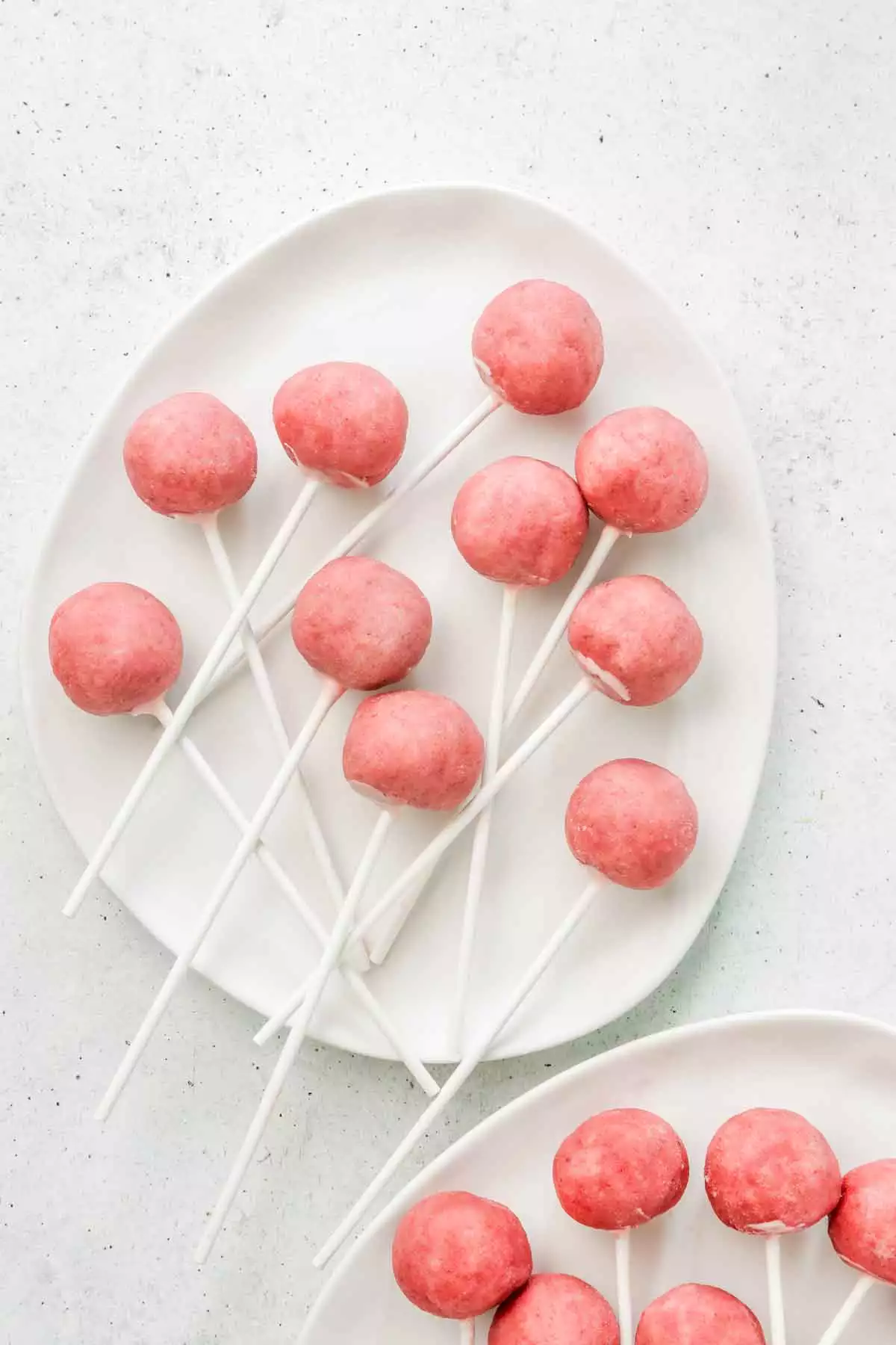 lollipop sticks with strawberry cake pops ready to dip
