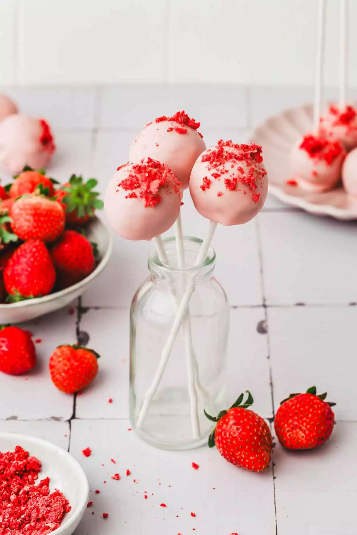 glass milk bottle with pink strawberry cake pops