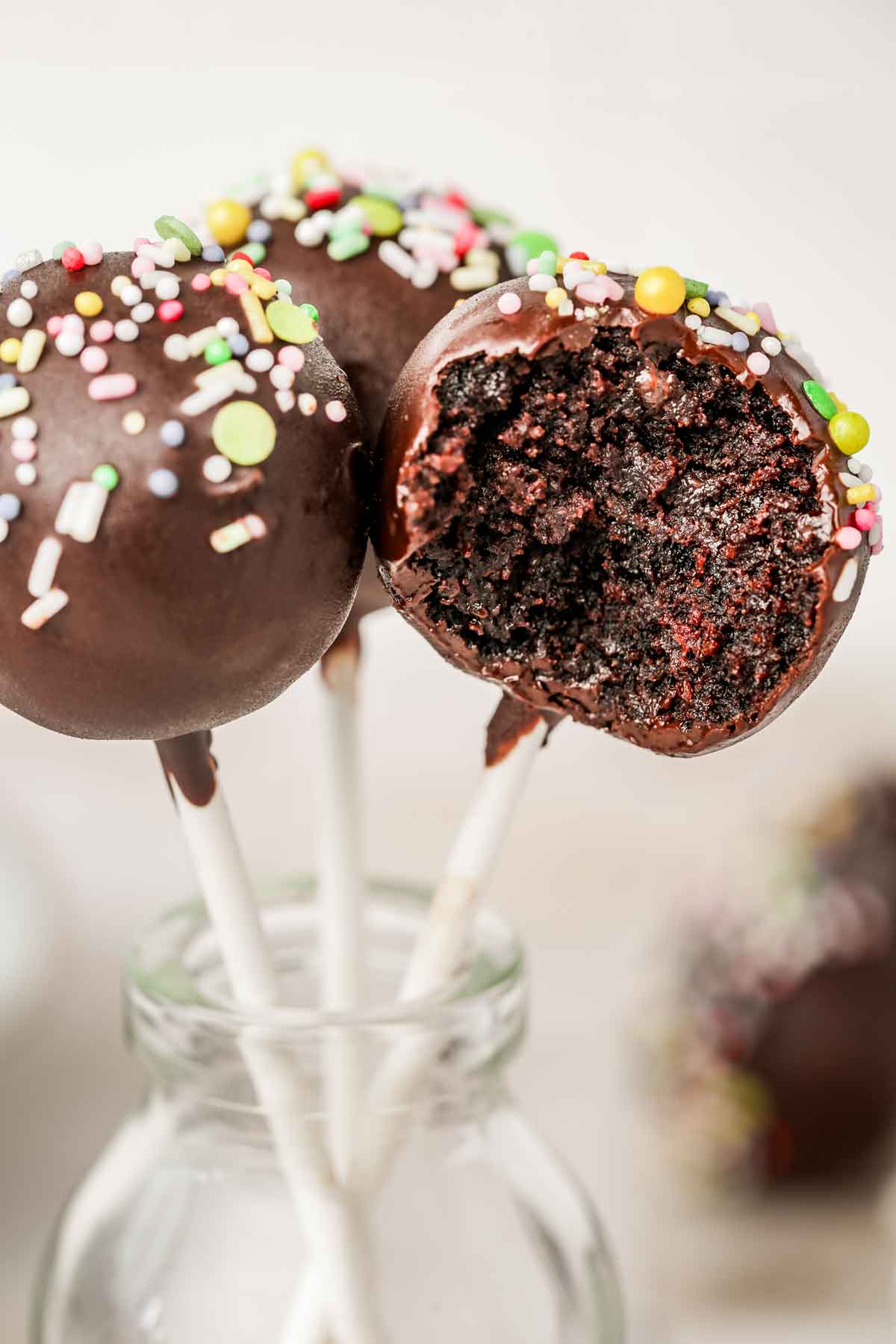 chocolate cake pops covered with chocolate and sprinkles
