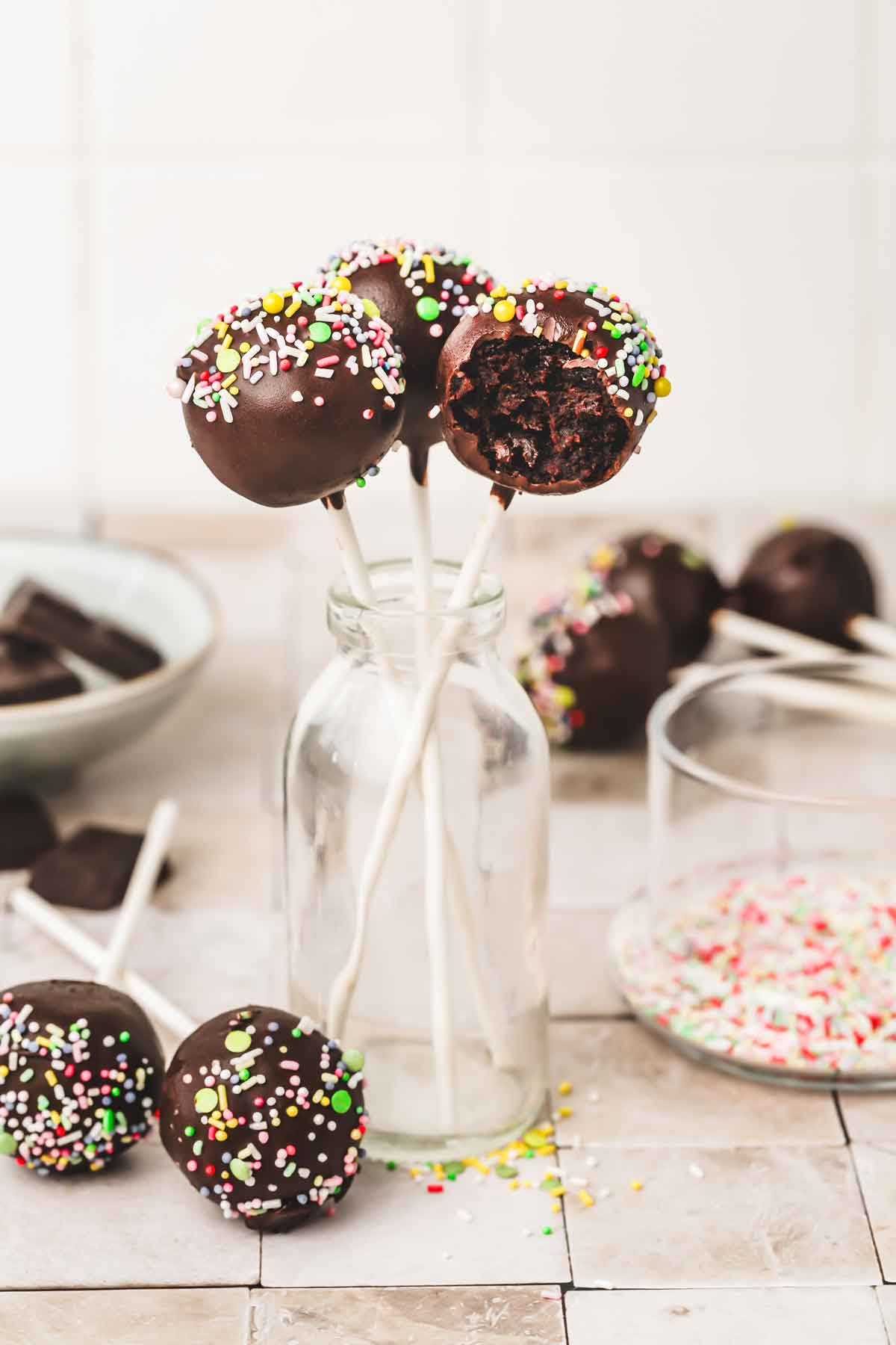 chocolate cake pops on a bottle of milk in a table