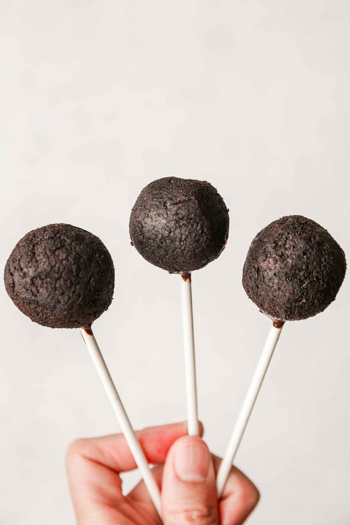 3 chocolate cake balls on lollipop sticks
