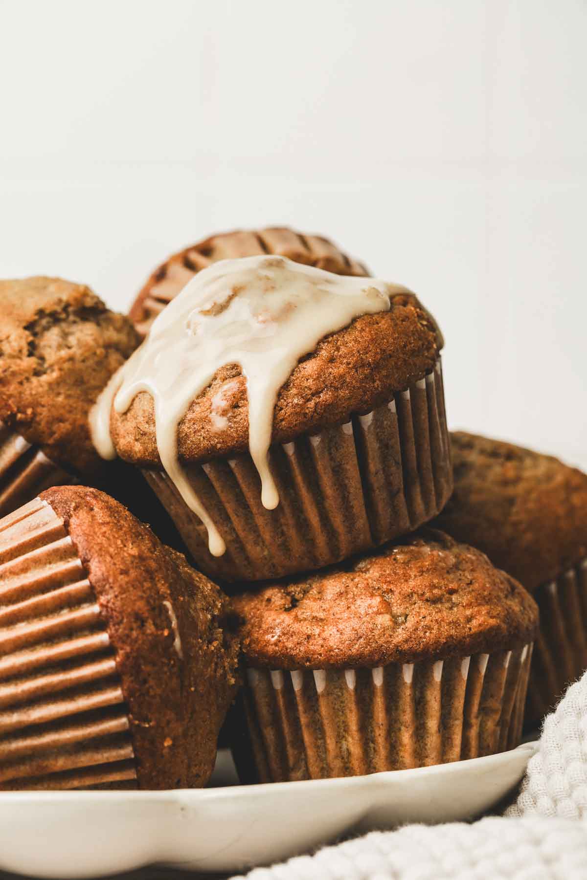 pumpkin banana muffins with maple glaze on a table