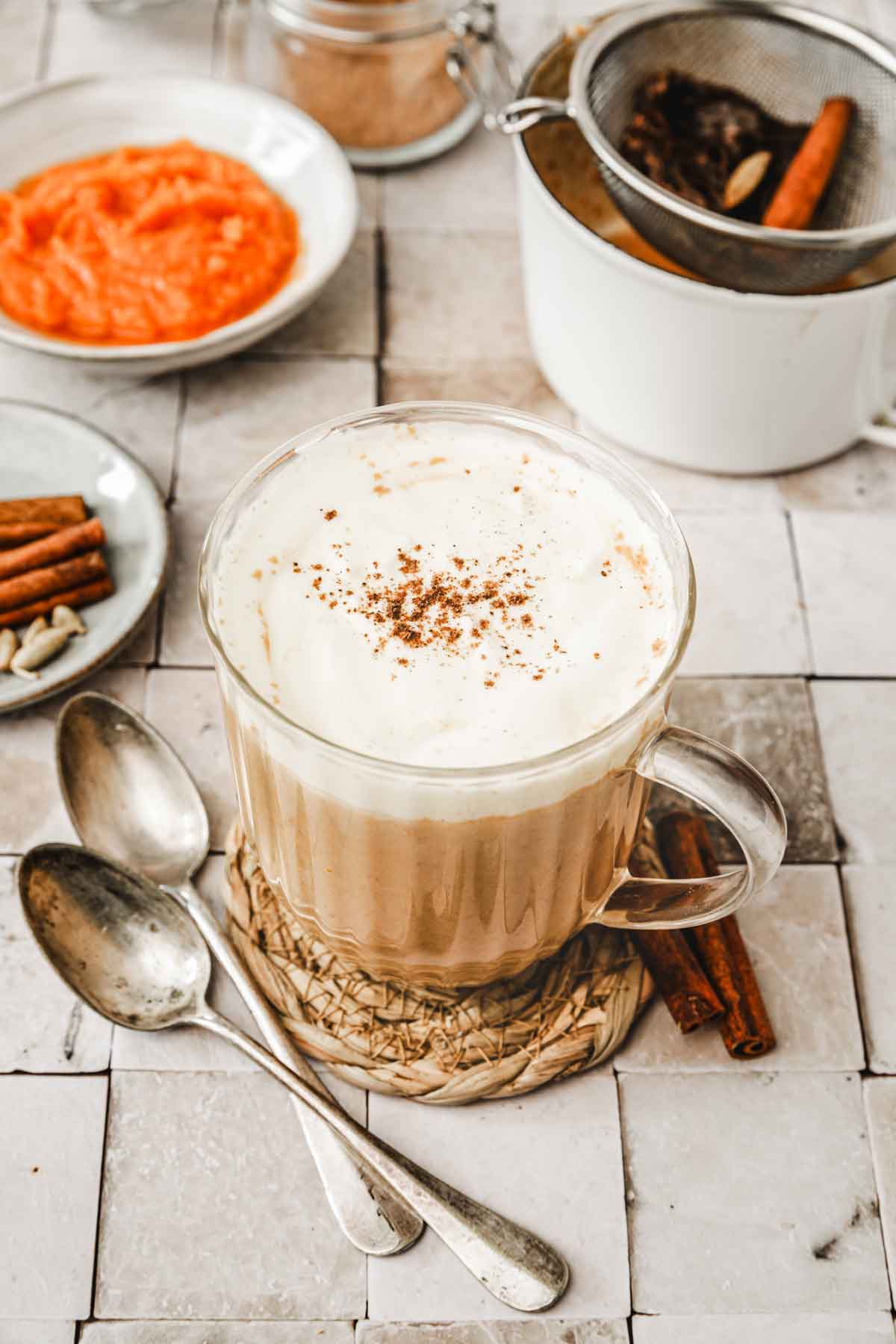 glass with pumpkin chai latte and whipped cream topping