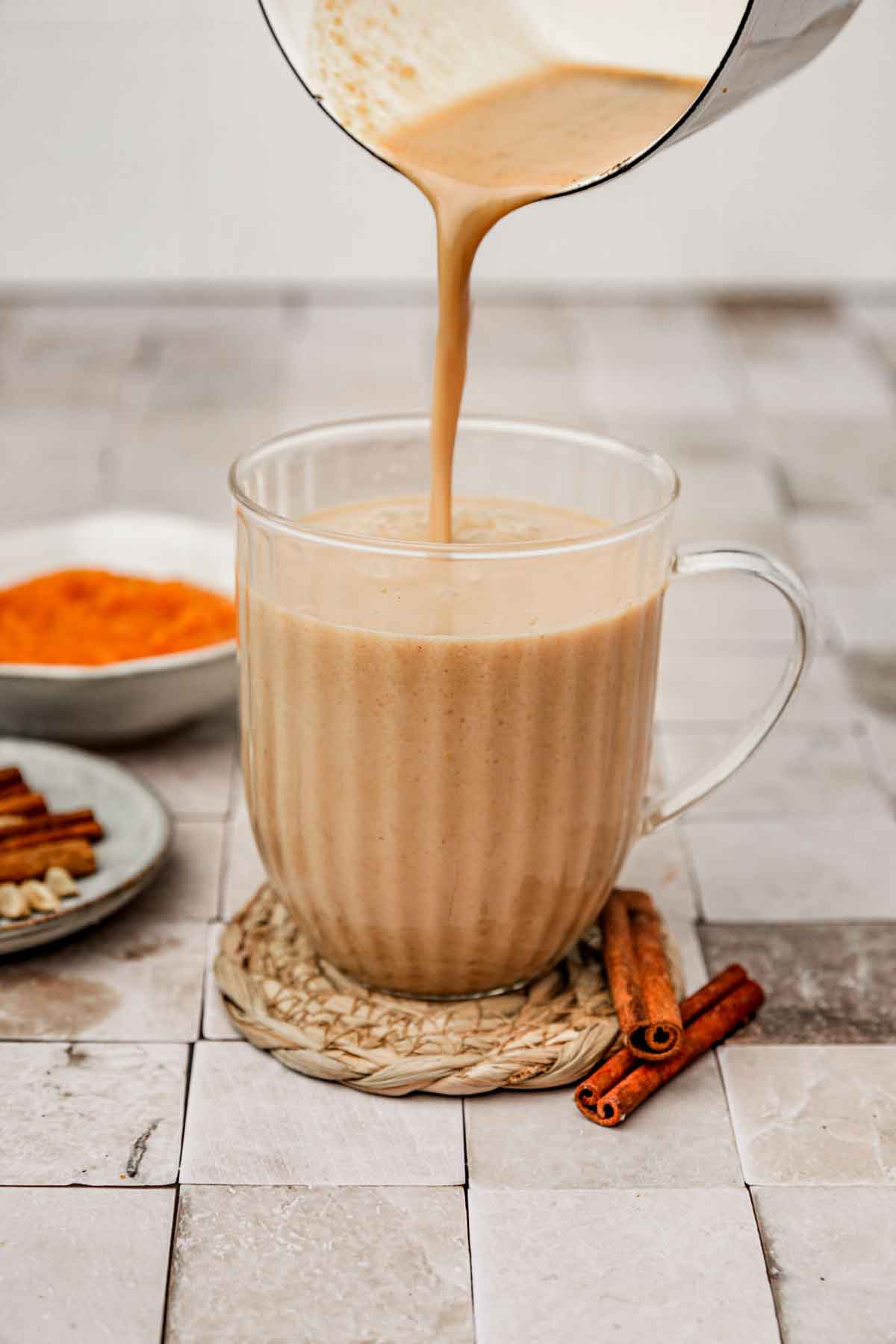 pumpkin chai latte mixture poured into a glass