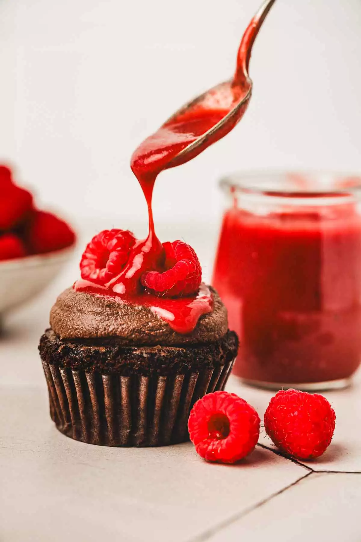 chocolate cupcakes with a raspberry sauce topping