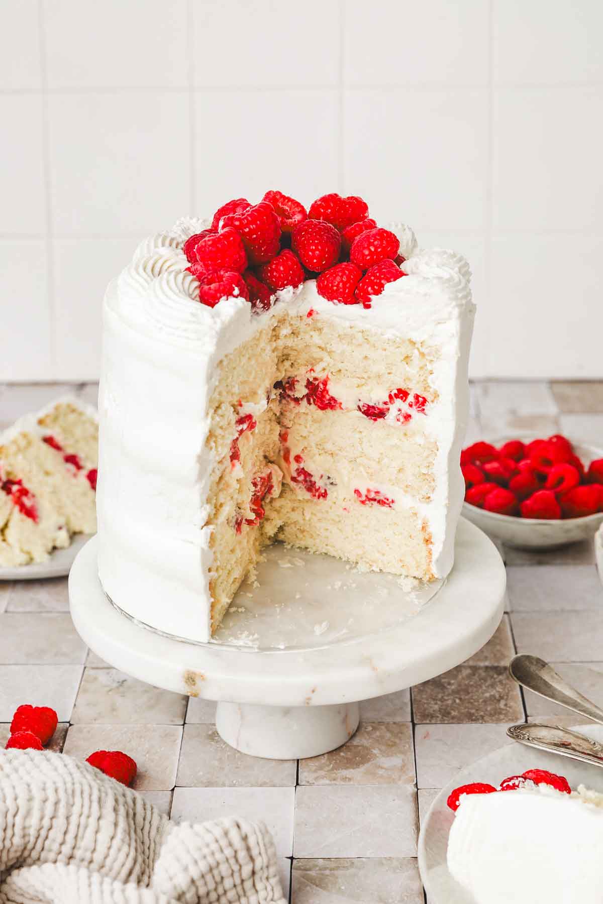 vanilla raspberry cake sliced on a table