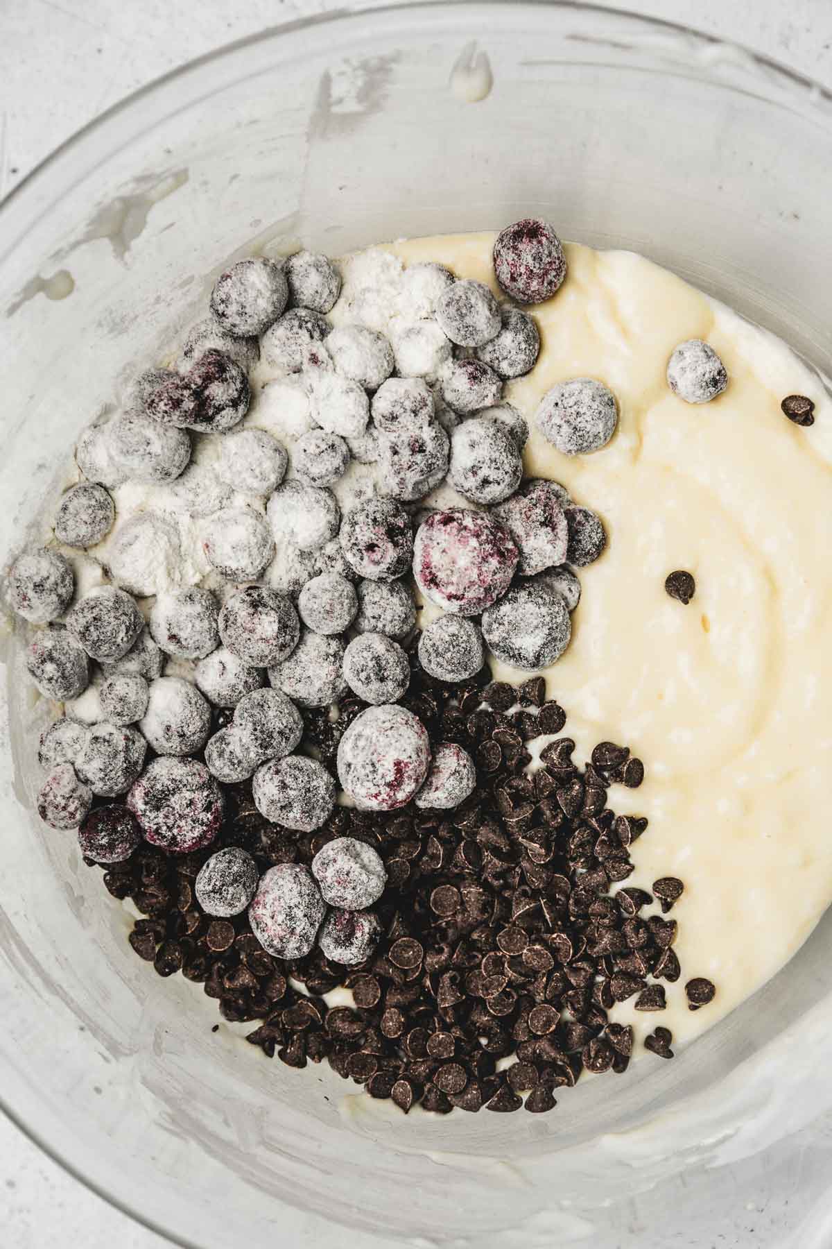 mixing bowl with frozen blueberries and mini chocolate chips