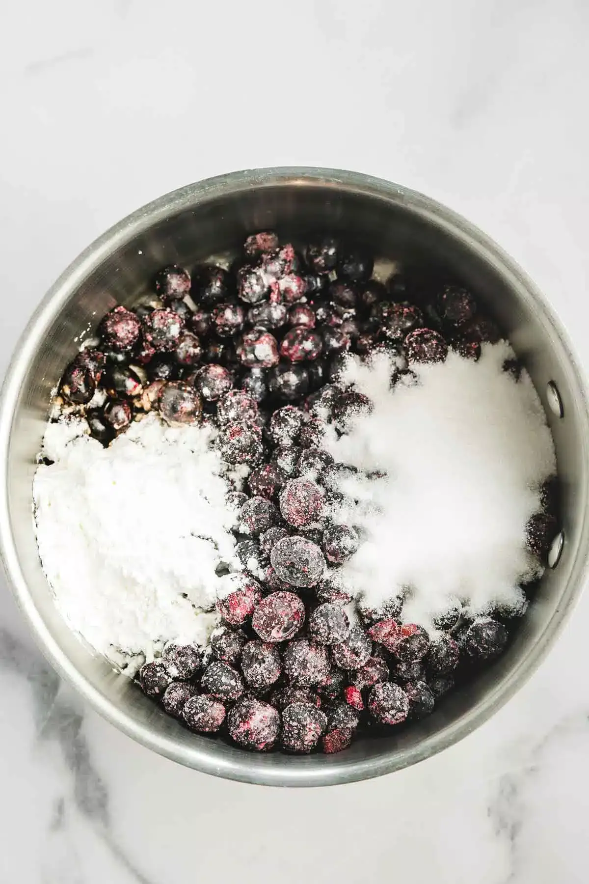 saucepan with blueberry and sugar