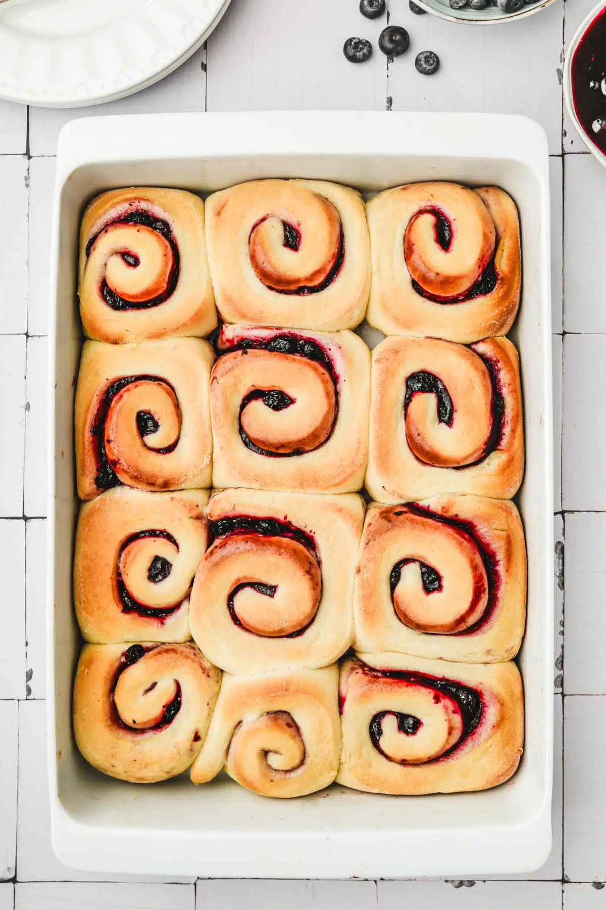 baking dish with baked blueberry rolls