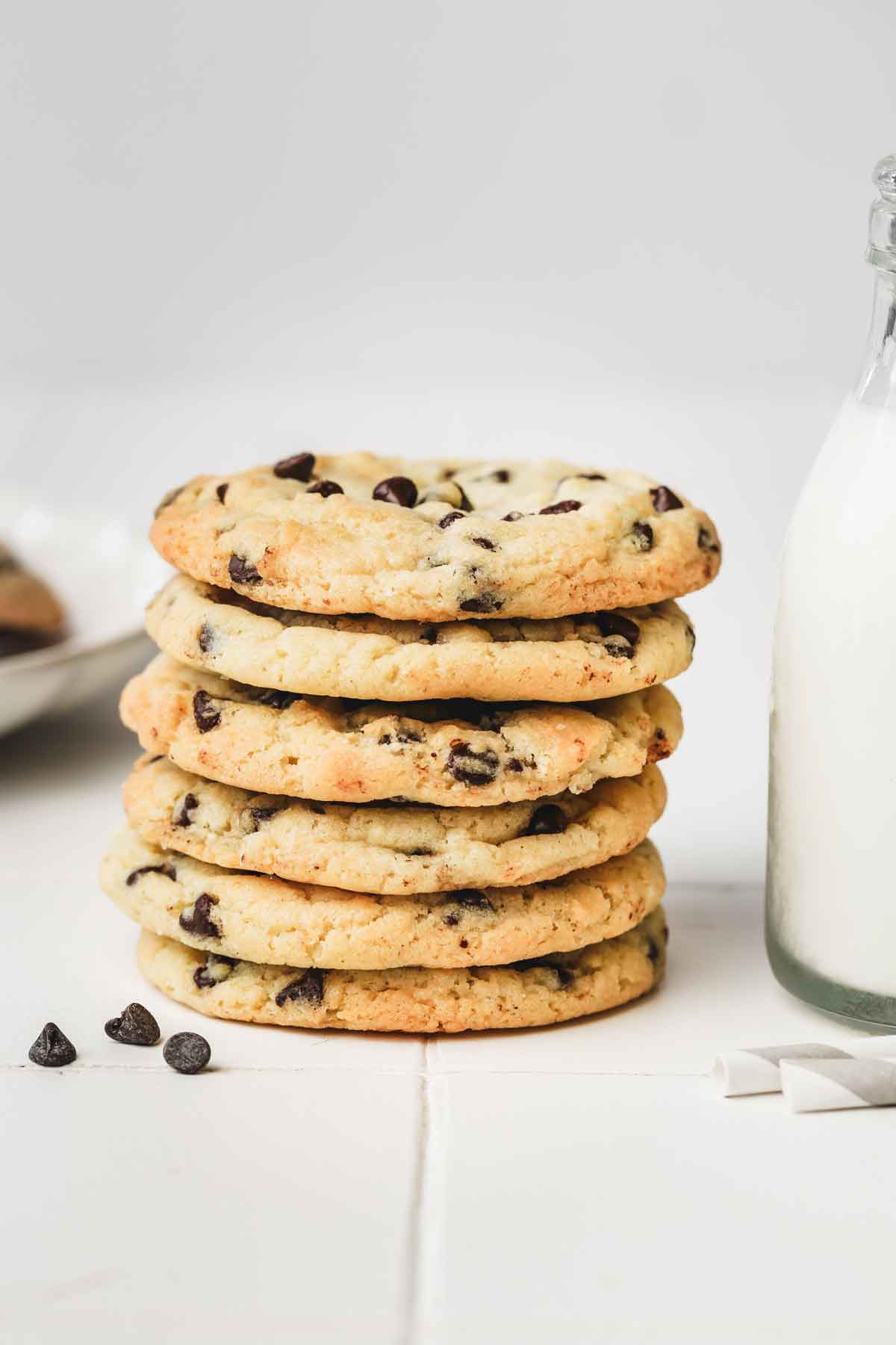 stacked chocolate chip cookies on a table