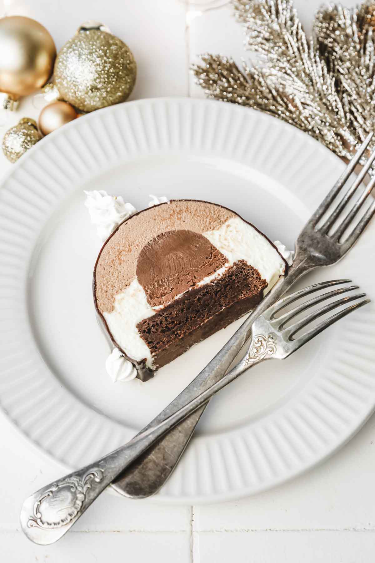 slice of triple chocolate log cake in a plate